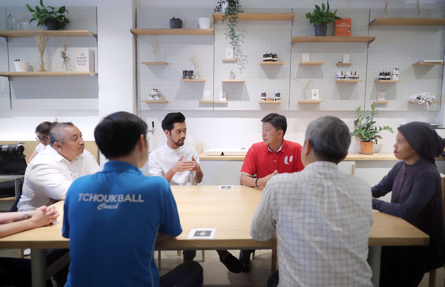 NTUC secretary-general Ng Chee Meng (in red) listening to freelancers speak about their concerns at a cafe in Havelock Road yesterday. The National Trades Union Congress' new $4 million fund will enable freelancers who are union members to claim high