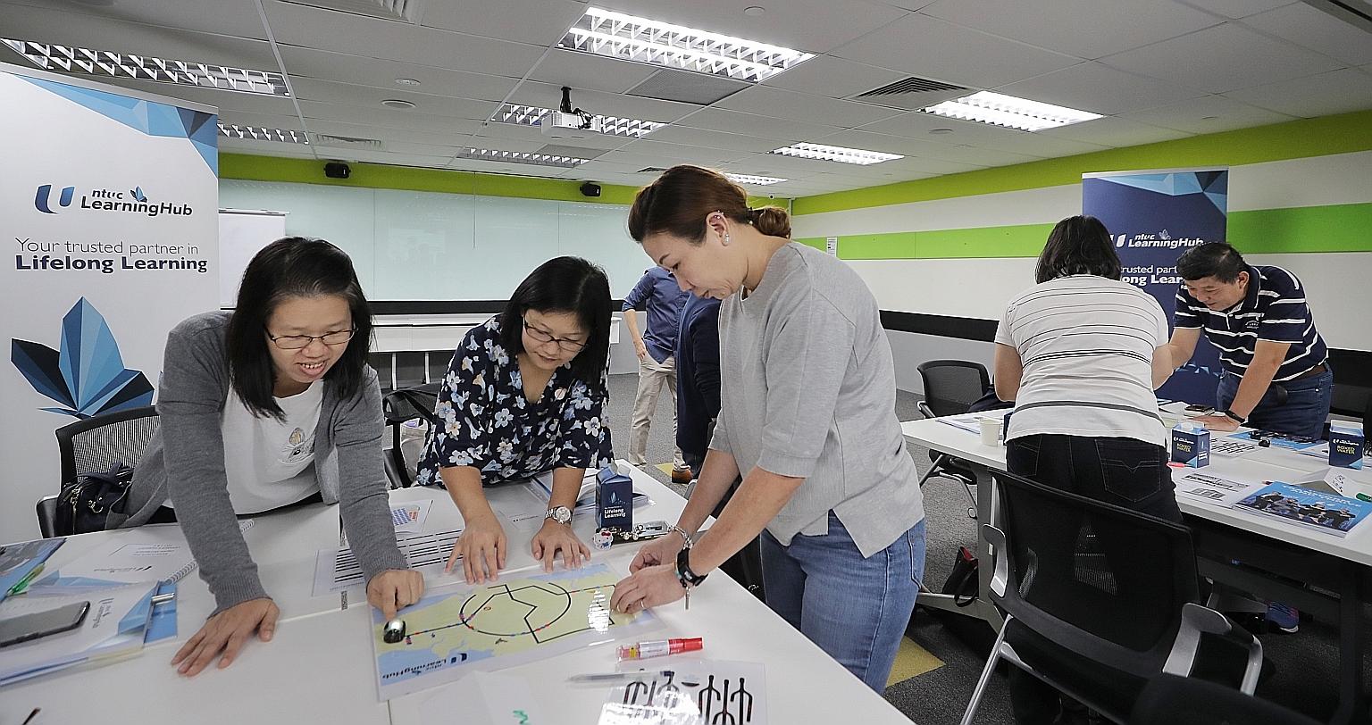 A coding class at the NTUC LearningHub in Bras Basah. Singaporeans can check which courses are eligible for the early use of their SkillsFuture Credit top-up on the MySkillsFuture portal. ST PHOTO: GAVIN FOO