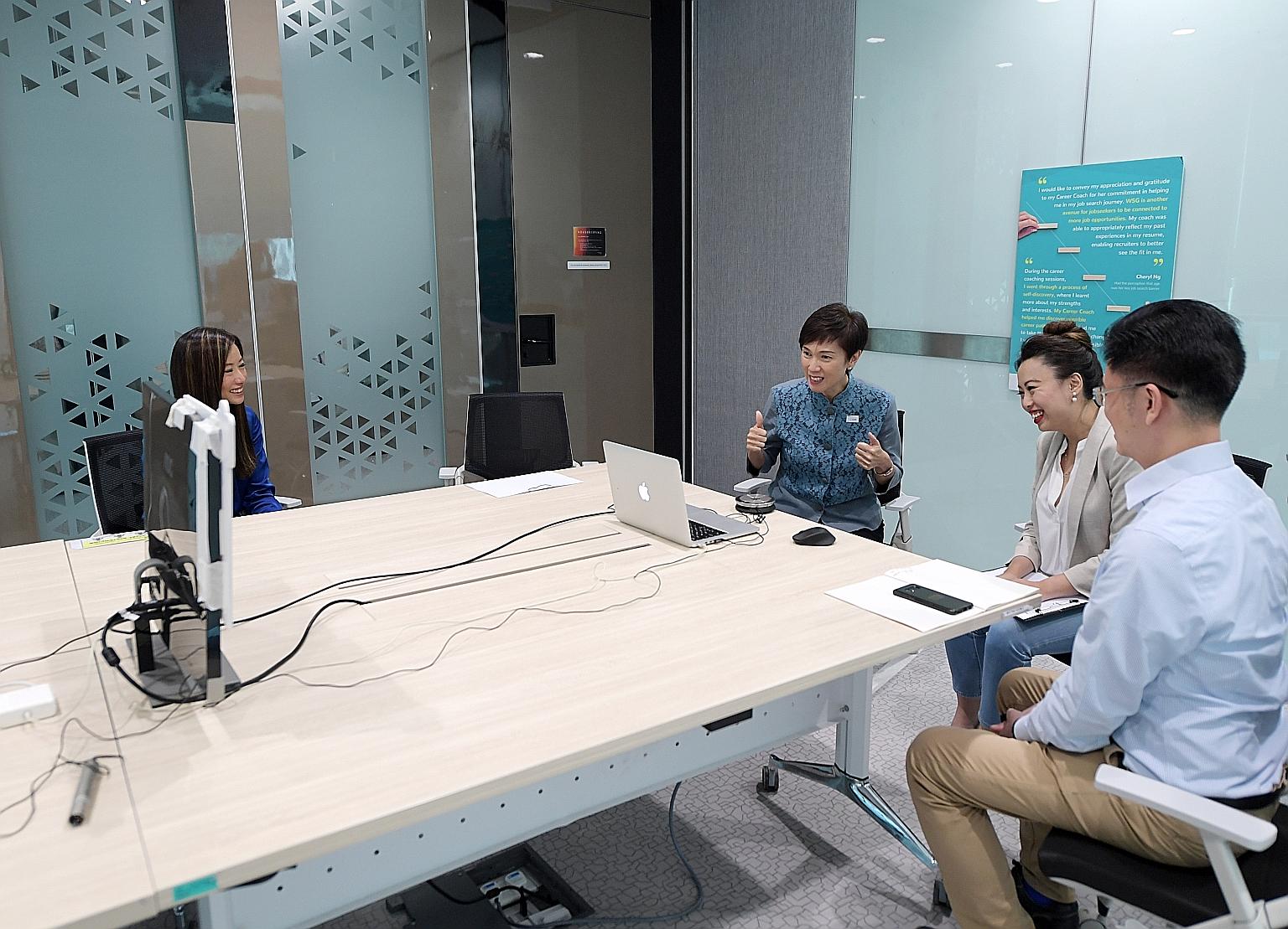 Manpower Minister Josephine Teo and School of Concepts director Mint Lim (second from right) interacting with jobseekers in a virtual networking session at Workforce Singapore's office yesterday, with Mr Chris Lau, senior career coach at WSG's career