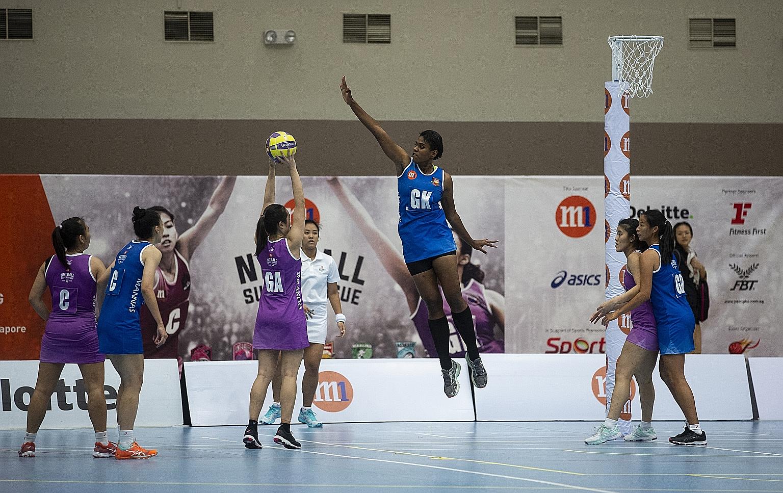 Sneakers Stingrays goal attacker Toh Kai Wei taking a shot as Mission Mannas' Ema Mualuvu attempts to block. The Stingrays were named champions after the NSL season was halted prematurely.