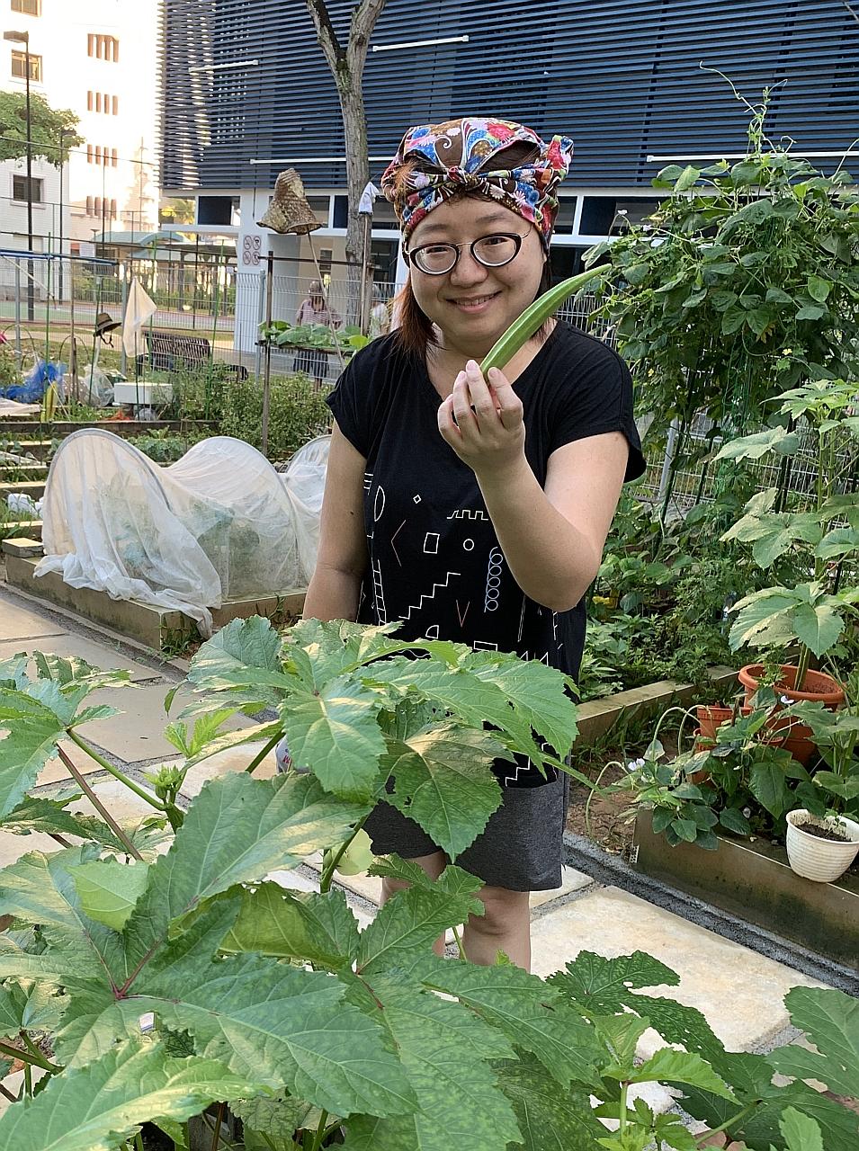 The writer with okra from her little plot in a community garden.