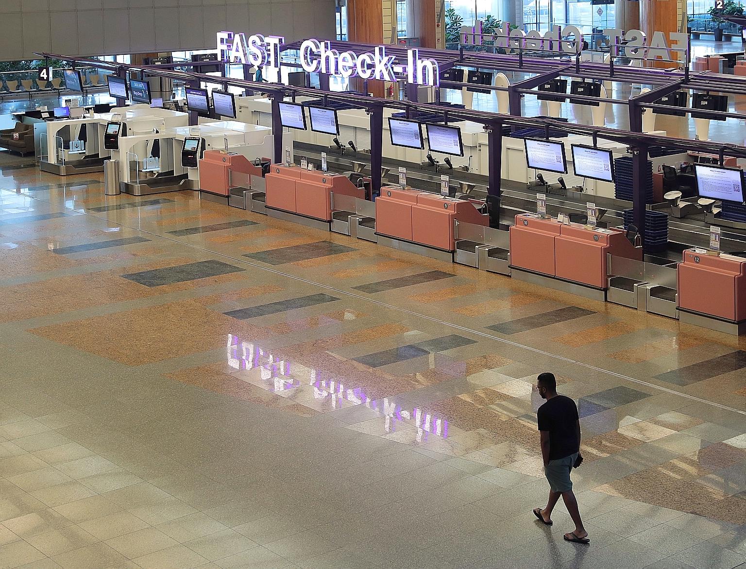 An almost-deserted Changi Airport Terminal 2 last Tuesday, due to a large number of cancelled flights. In the wake of the virus outbreak, cities and countries have closed their borders and people are staying home.