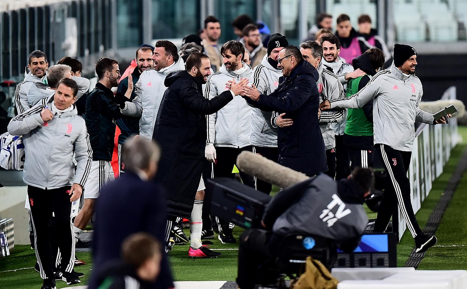 Juventus striker Gonzalo Higuain and manager Maurizio Sarri, seen celebrating their last win, will take a pay cut as the Italian champions attempt to tide over the financial pressure they face with the lack of competitive matches.