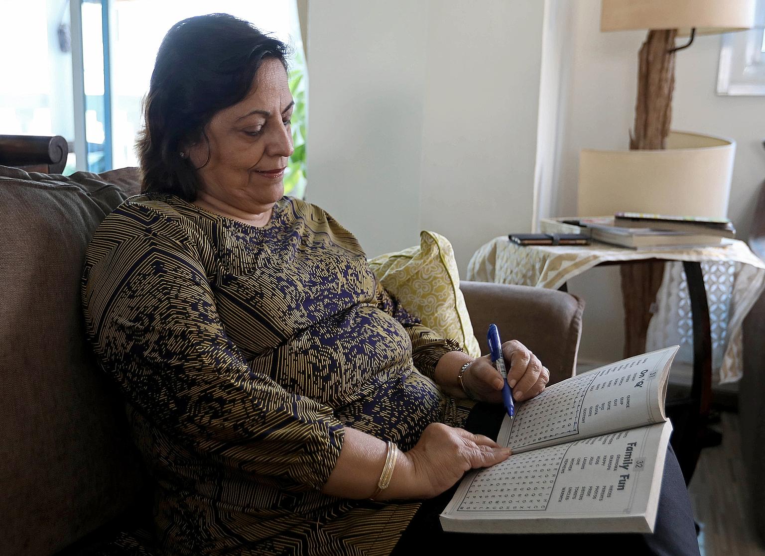 Retiree Sitabai Mohan keeping her mind active to prevent dementia by completing a word search on March 21. Madam Mohan has been taking the social-distancing measures in her stride. She also does some simple exercises such as walking to the bus stop a