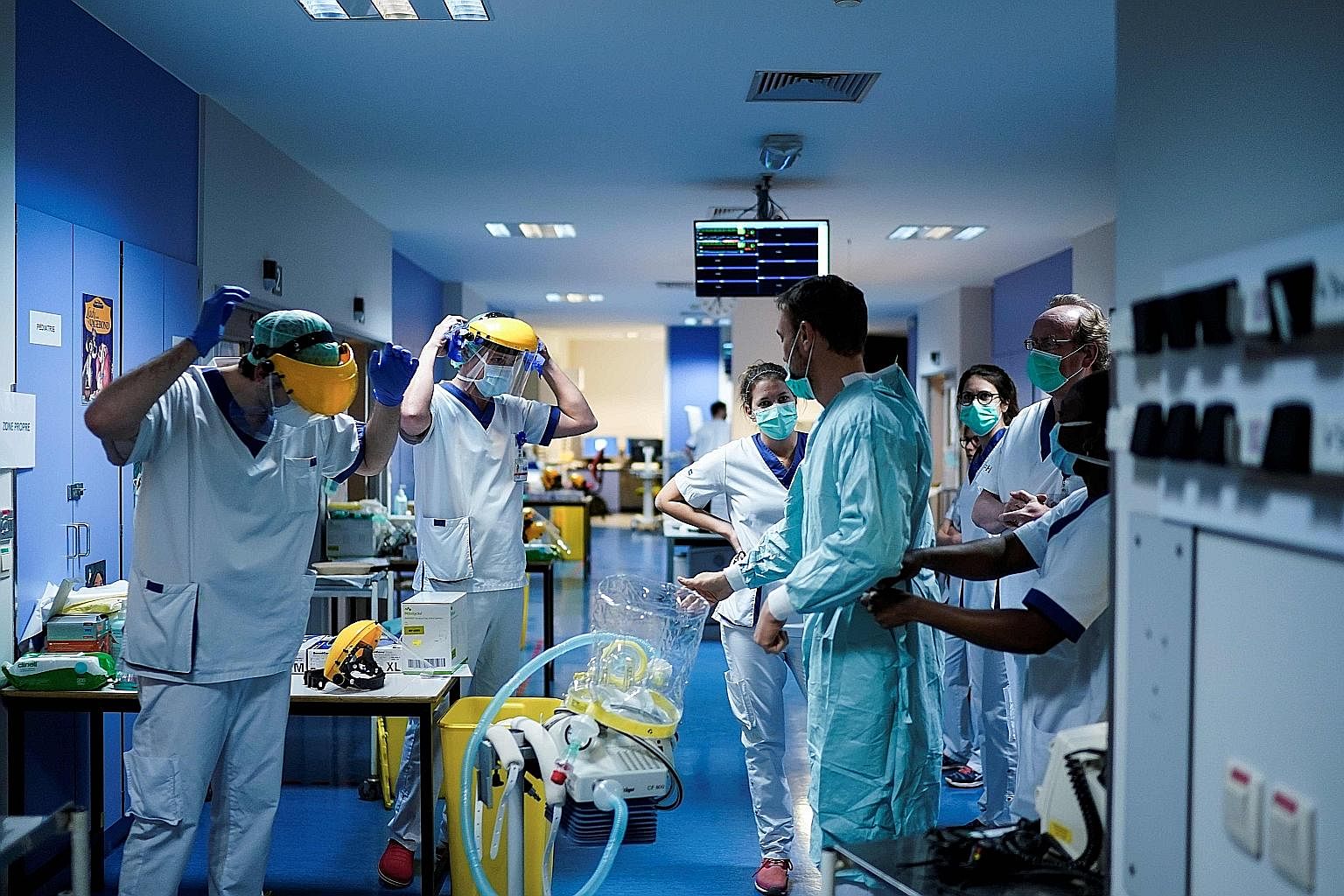Medical staff putting on protective gear last Friday before treating Covid-19 patients at the Erasme Hospital in Brussels. The adoption of a road map for the global community is vital because there will be another outbreak in the future, perhaps more