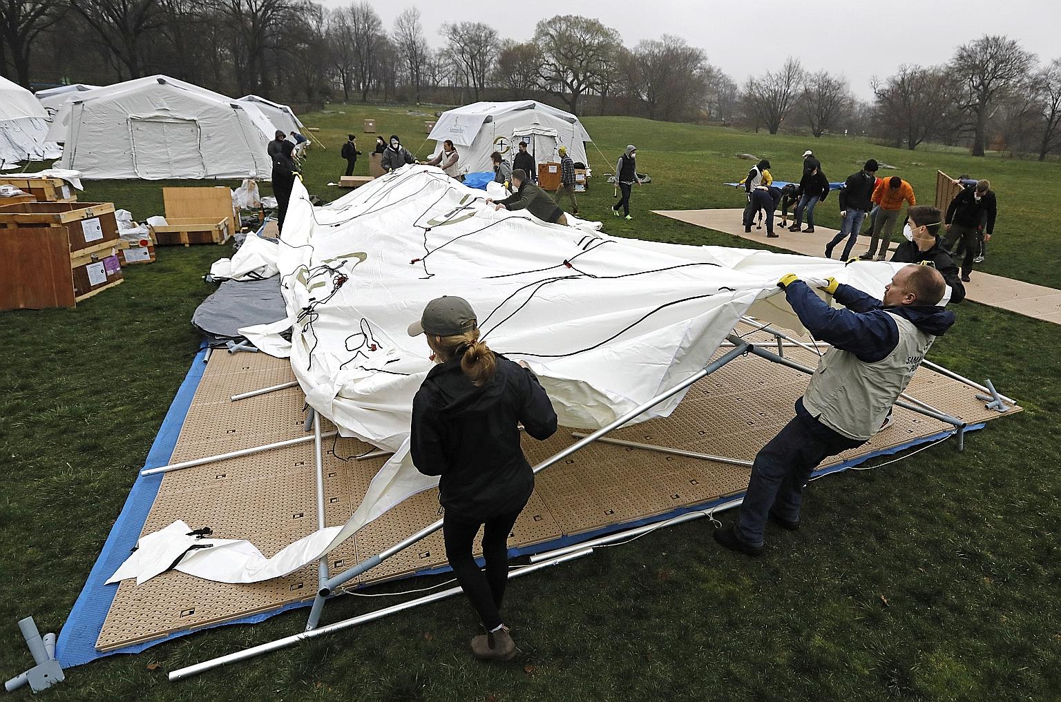 Staff and volunteers from Samaritan's Purse, a US-based Christian global relief agency, erecting tents for a makeshift hospital in Central Park in New York on Sunday. The site, located right across from one of the facilities in the Mount Sinai hospit