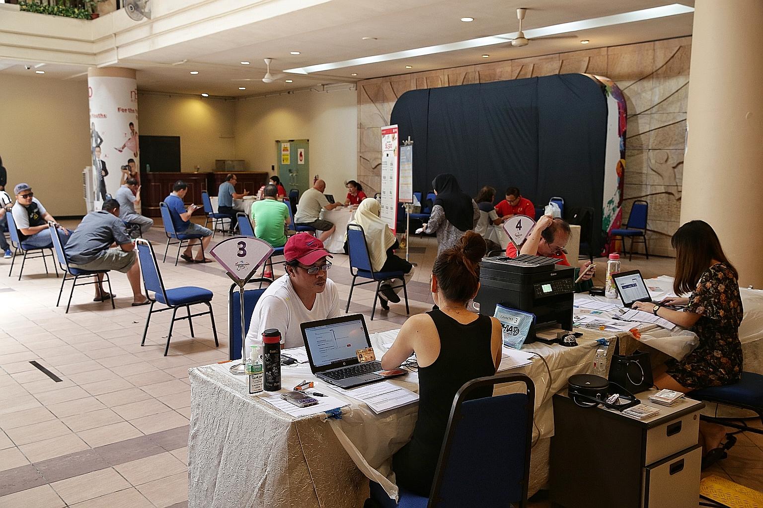 Private-hire and taxi drivers at the pop-up care centre at Downtown East yesterday. The centre aims to help drivers apply for NTUC's assistance funds, learn more about other forms of immediate assistance and explore other job options.