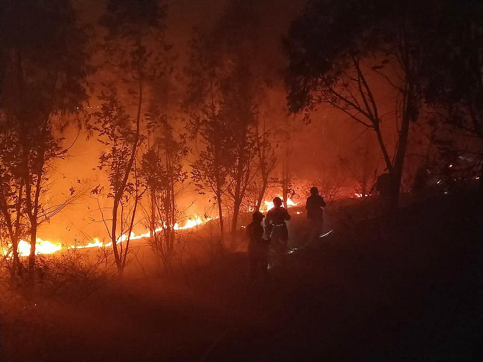 Firemen battling a forest fire in Xichang in China's Sichuan province yesterday.