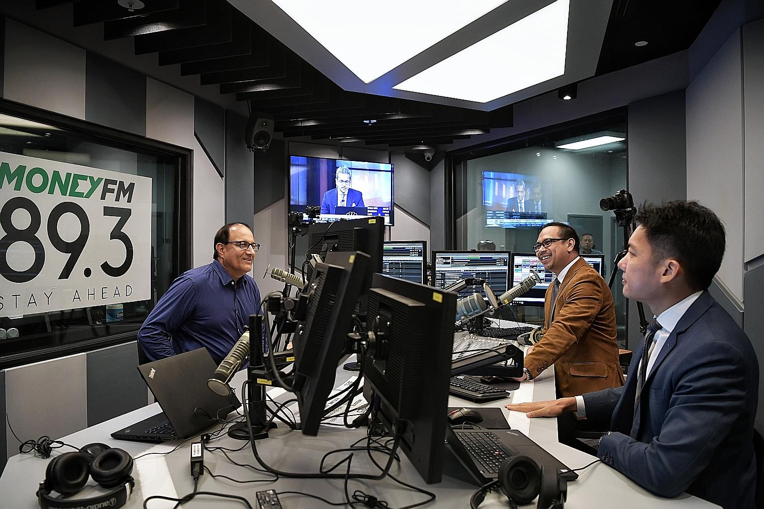 Minister for Communications and Information S. Iswaran during yesterday's radio interview with Money FM 89.3 co-hosts Ryan Huang (right) and Elliott Danker. ST PHOTO: KUA CHEE SIONG
