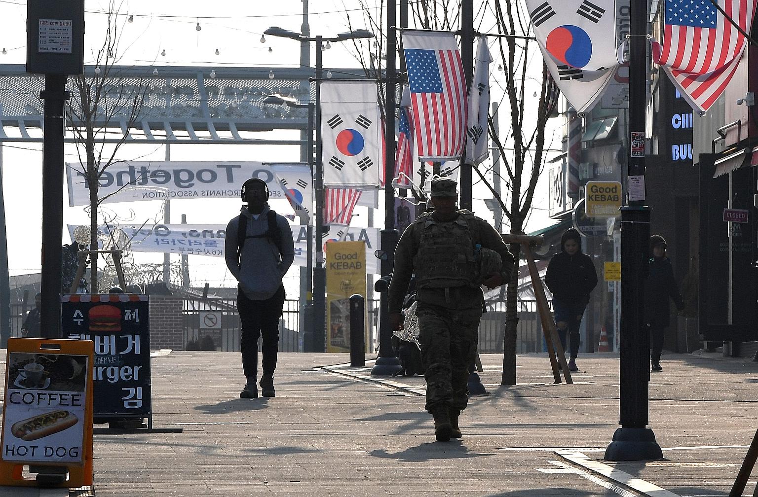 In this 2019 photo, a US soldier is seen in a shopping zone outside US Camp Humphreys in Pyeongtaek city, South Korea. The decades-old military alliance between the US and South Korea was dealt a blow yesterday when the US military put almost half of