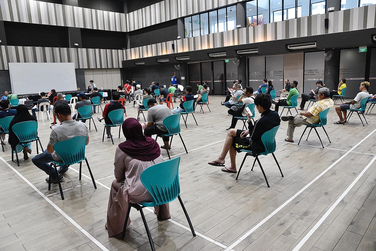 People waiting their turn to submit their applications for the Temporary Relief Fund at Nee Soon East Community Club yesterday - the first day that Singaporeans and permanent residents could apply for the scheme.