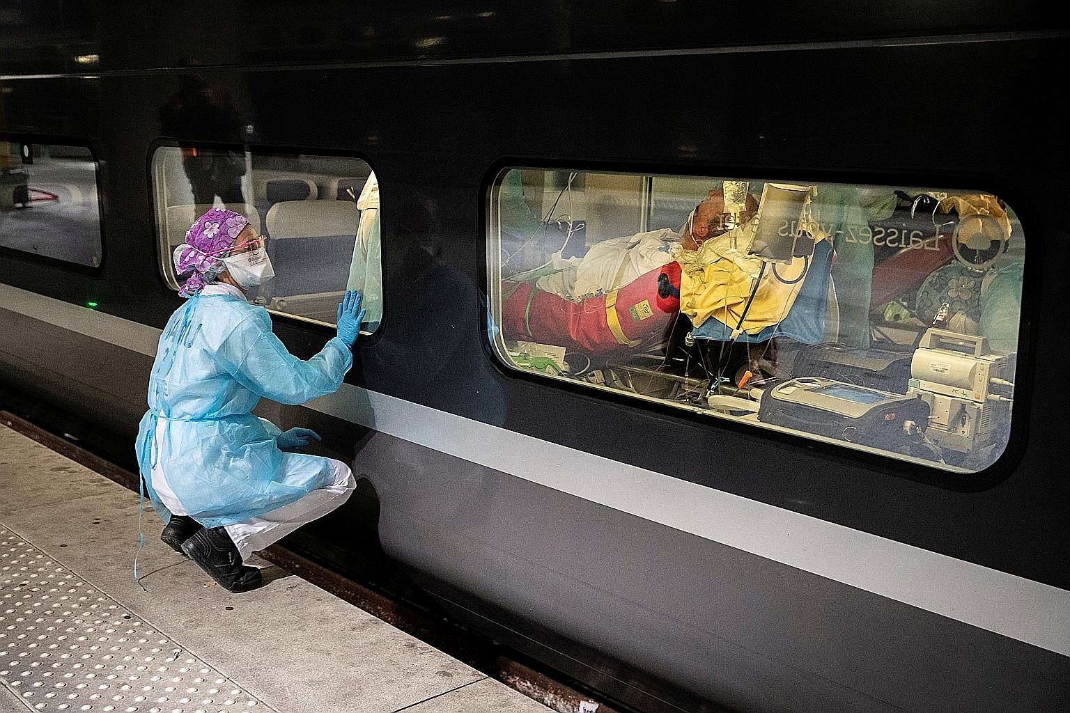 A medical worker looking into a train that was to evacuate Covid-19 patients from Paris region hospitals to Brittany on Wednesday. PHOTO: AGENCE FRANCE-PRESSE