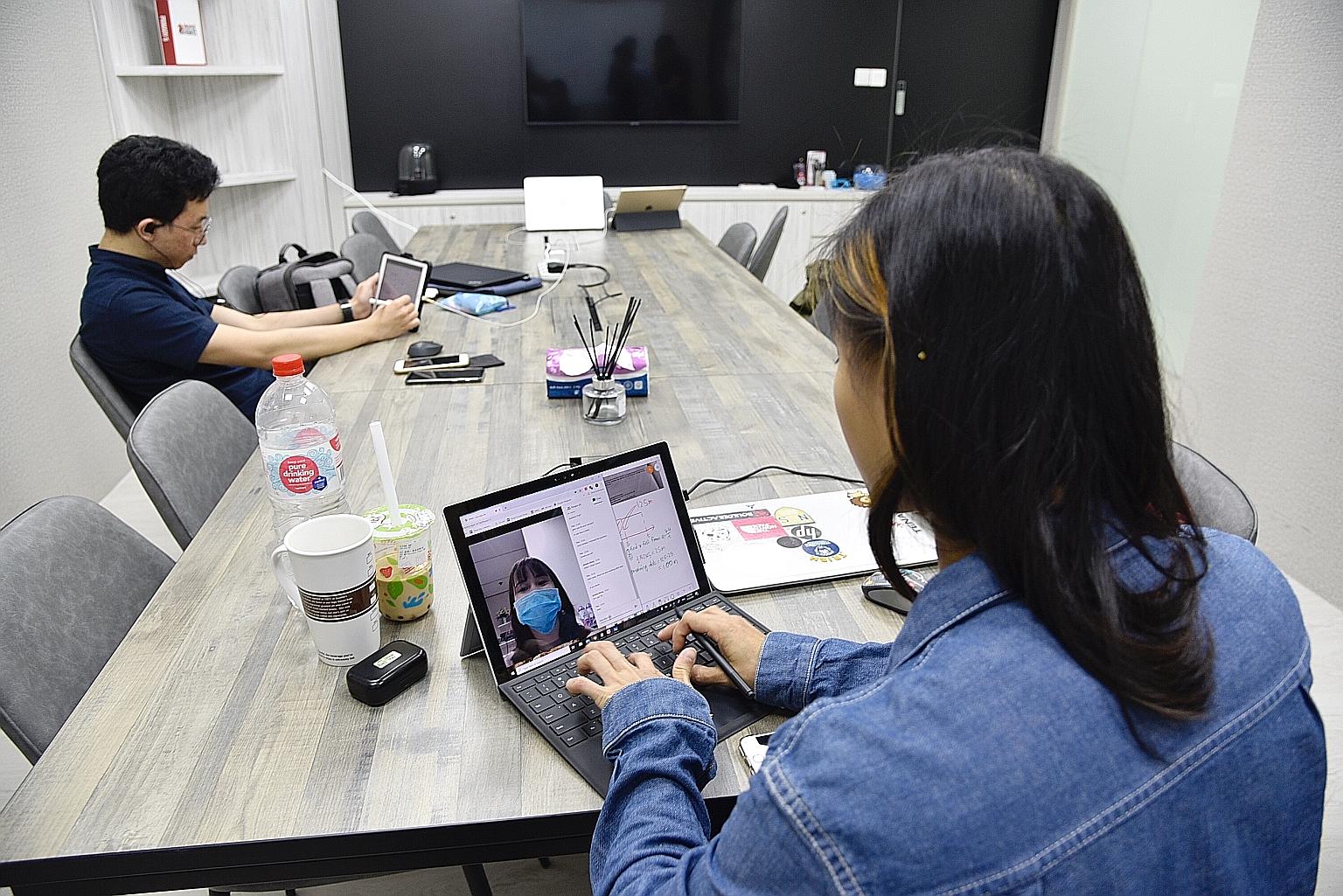 Ms Tricia Yau, a tutor at Aspire Hub, conducting a live-stream session with a student this week. The authorities suspended all centre-based classes from last Friday until the end of this month to reduce intermingling of students from different school