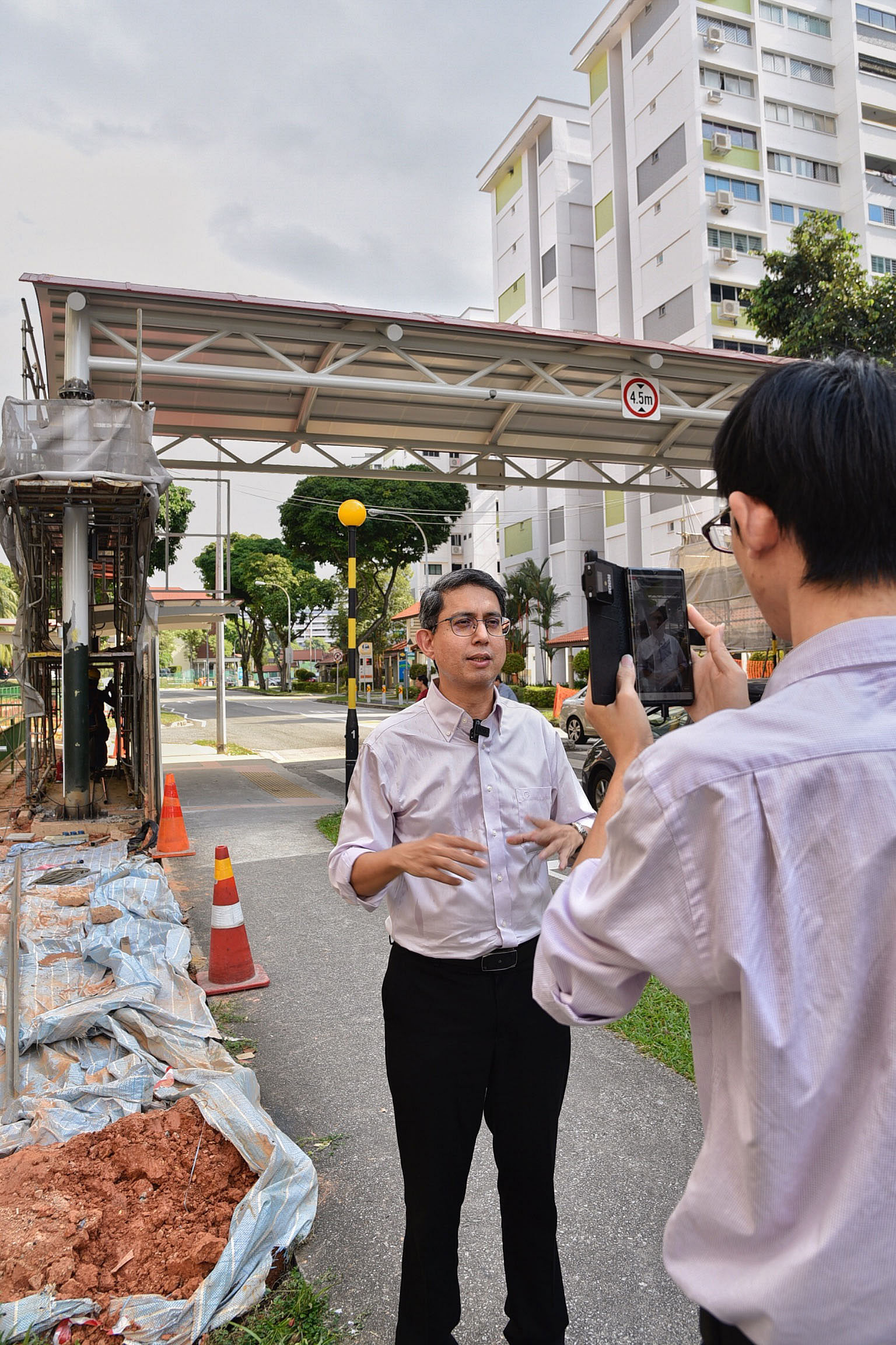 Senior Parliamentary Secretary Muhammad Faishal Ibrahim doing a Facebook Live broadcast about a new covered walkway for his Nee Soon Central constituents. Associate Professor Faishal says he has used Facebook Live to answer residents' questions, such