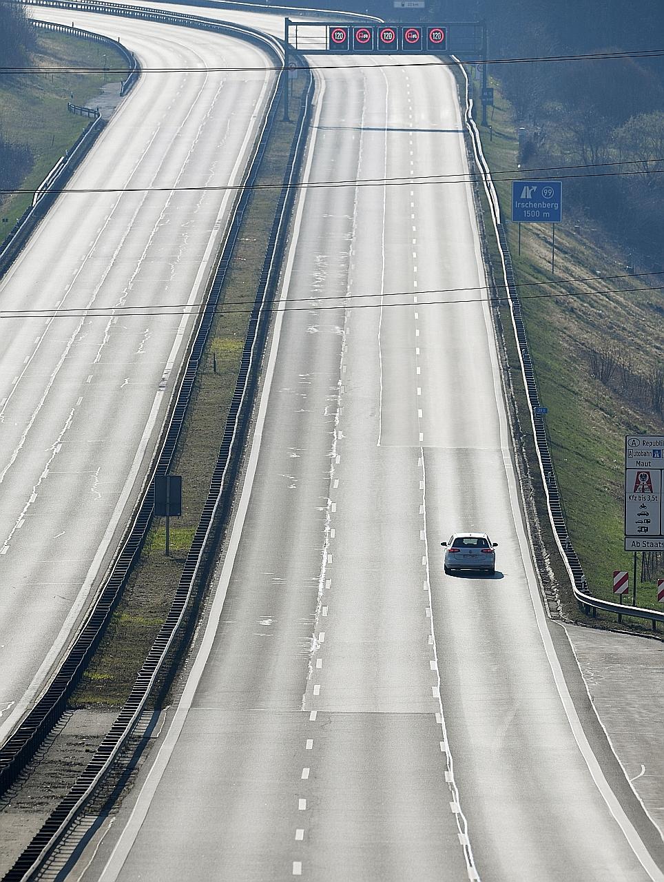 A lone car on a motorway near southern Germany. The country's 16 states have agreed to maintain curbs on movement until April 19.