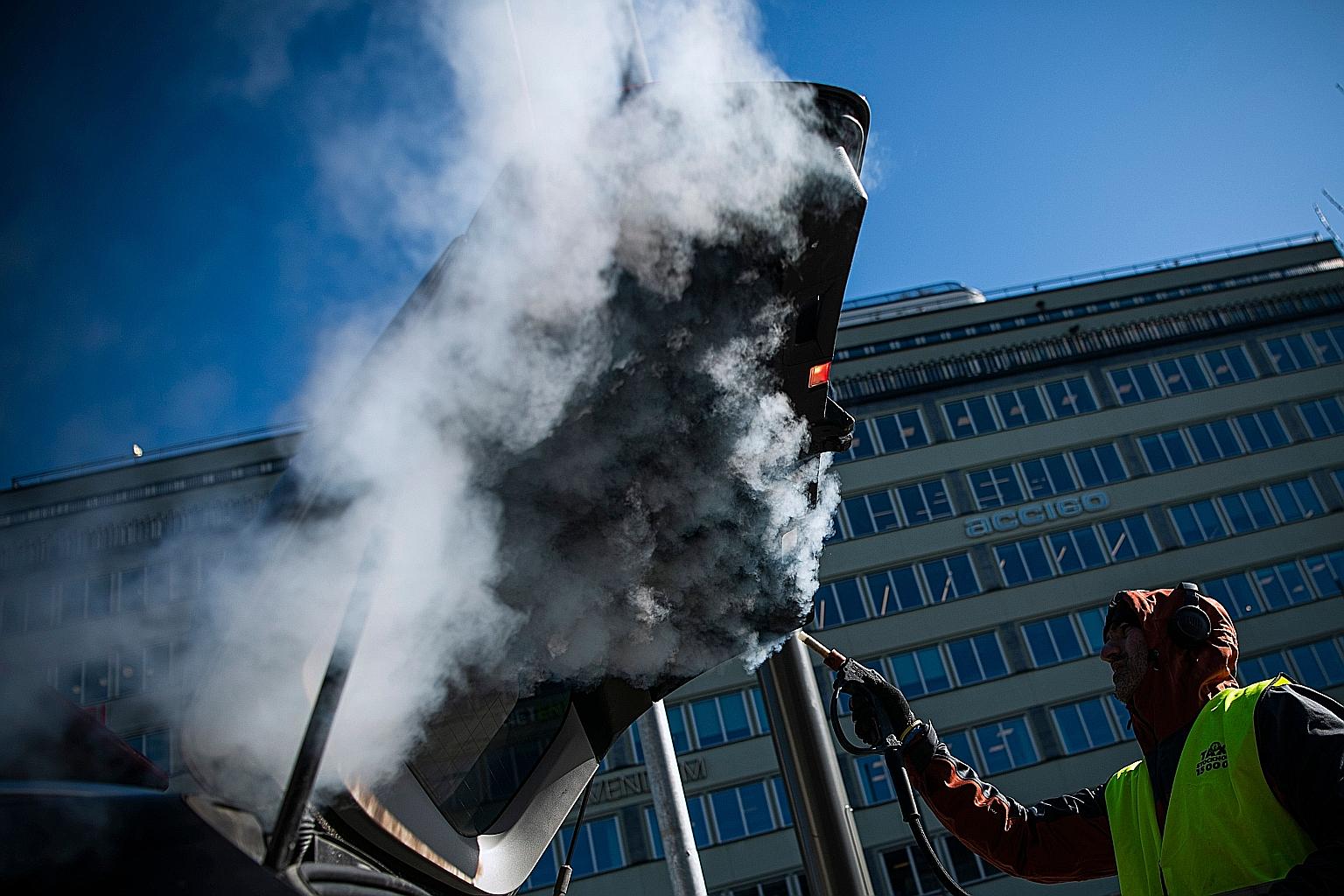 A man cleaning and disinfecting a taxi in Stockholm on Thursday, to prevent the spread of the coronavirus. The number of Swedish deaths rose to 373 yesterday, up by 12 per cent from Friday.