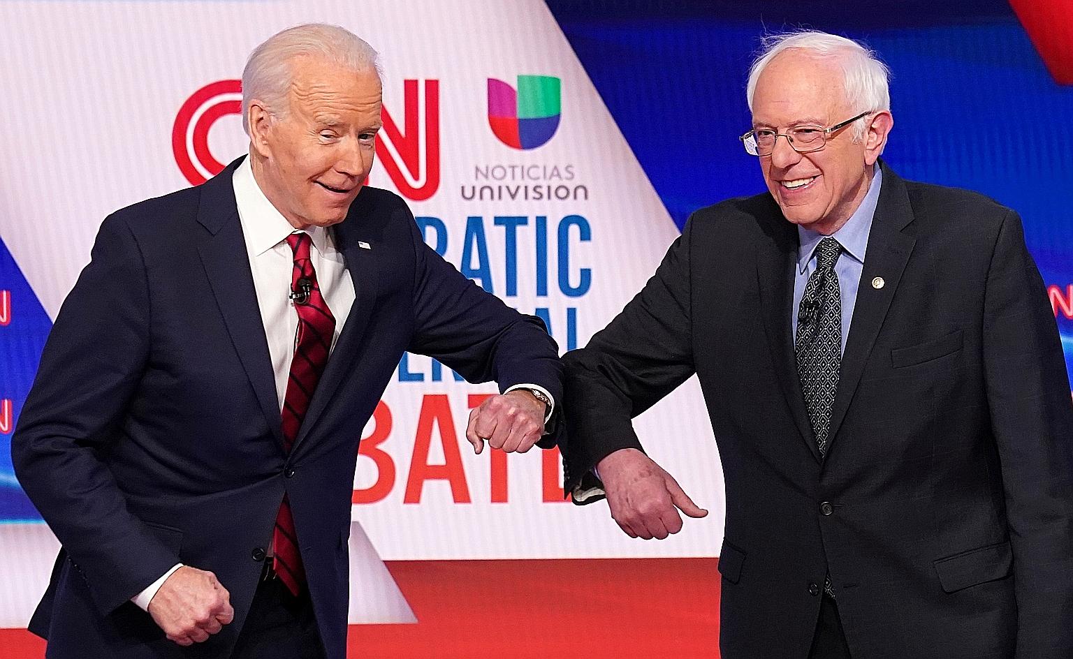 Mr Joe Biden and Senator Bernie Sanders doing an elbow bump instead of a handshake ahead of a Democratic Party debate in Washington last month.