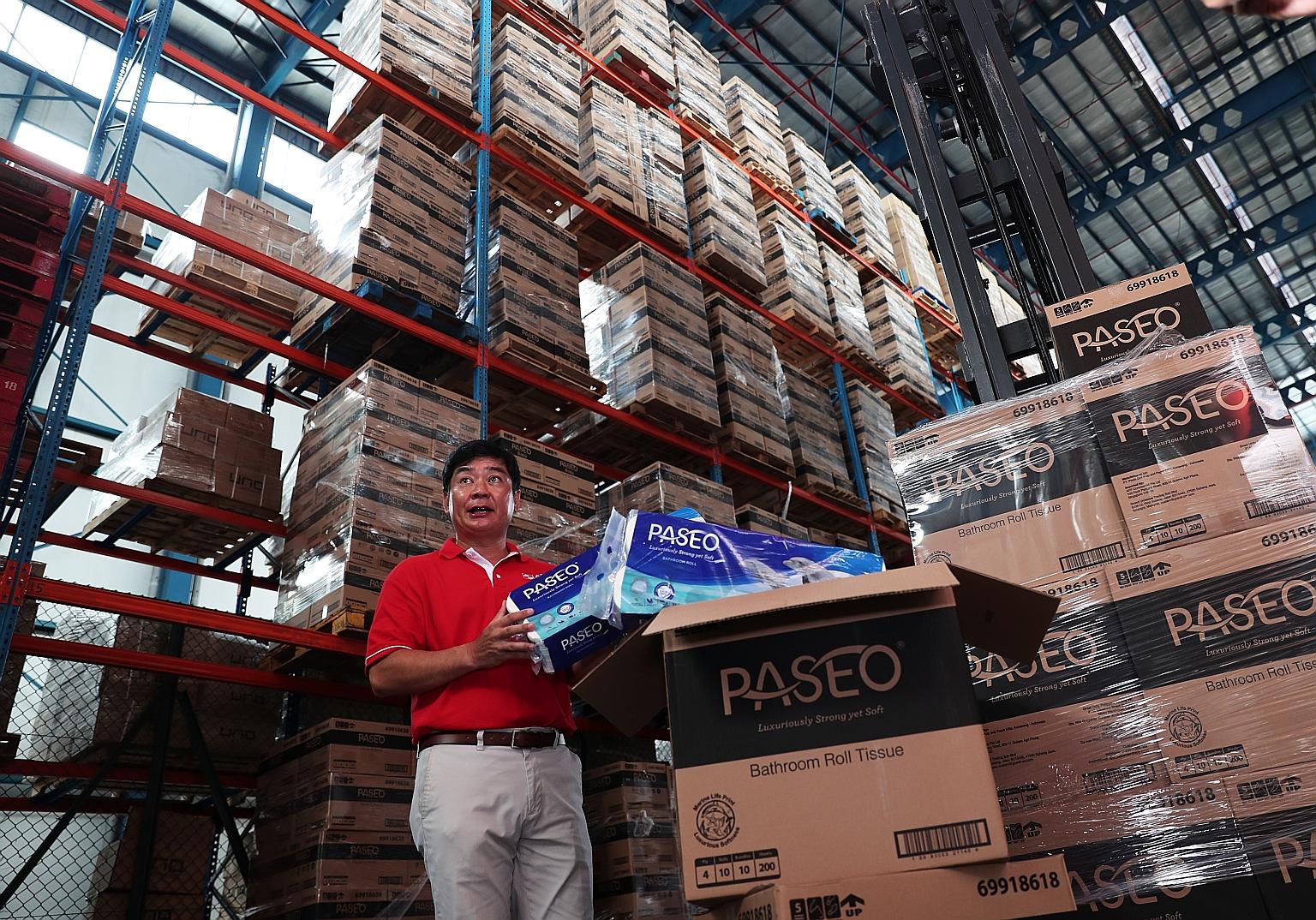 Mr Bernard Tan, president for Sinar Mas in Singapore, checking yesterday on toilet rolls set for delivery.