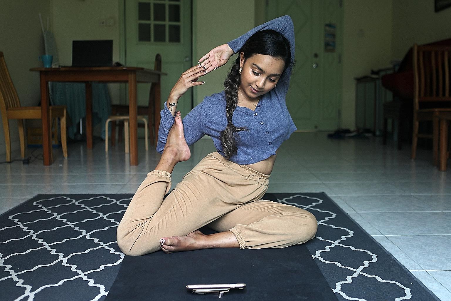 Straits Times reporter Malavika Menon practising a variation of eka pada rajakapotasana, or the one-legged king pigeon pose, at home.
