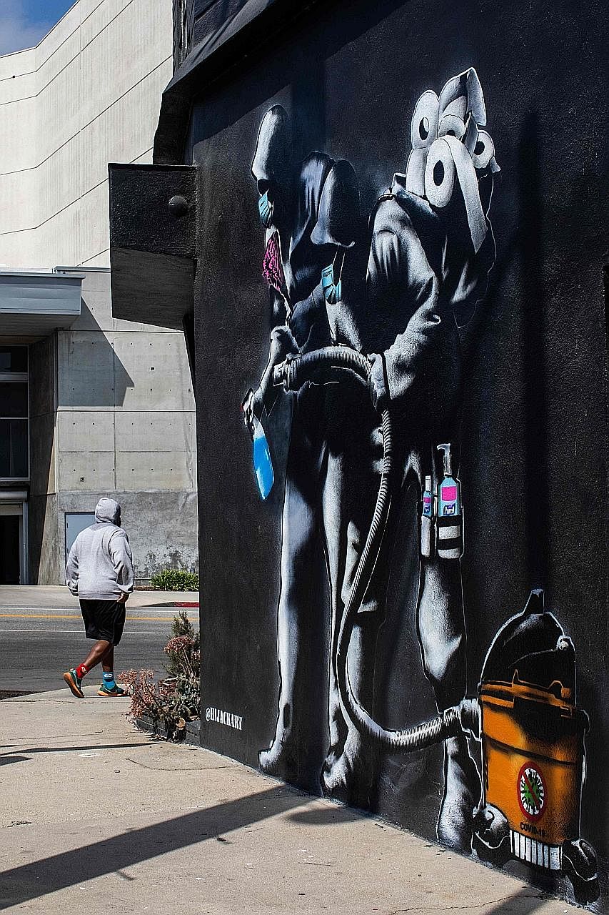An apocalyptic mural in Los Angeles, California, by Hijackhart, where soldiers wearing face masks fight the Covid-19 disease with disinfectant and hand sanitiser amid the coronavirus pandemic. Delayed responses by China and the US (and Europe) have i