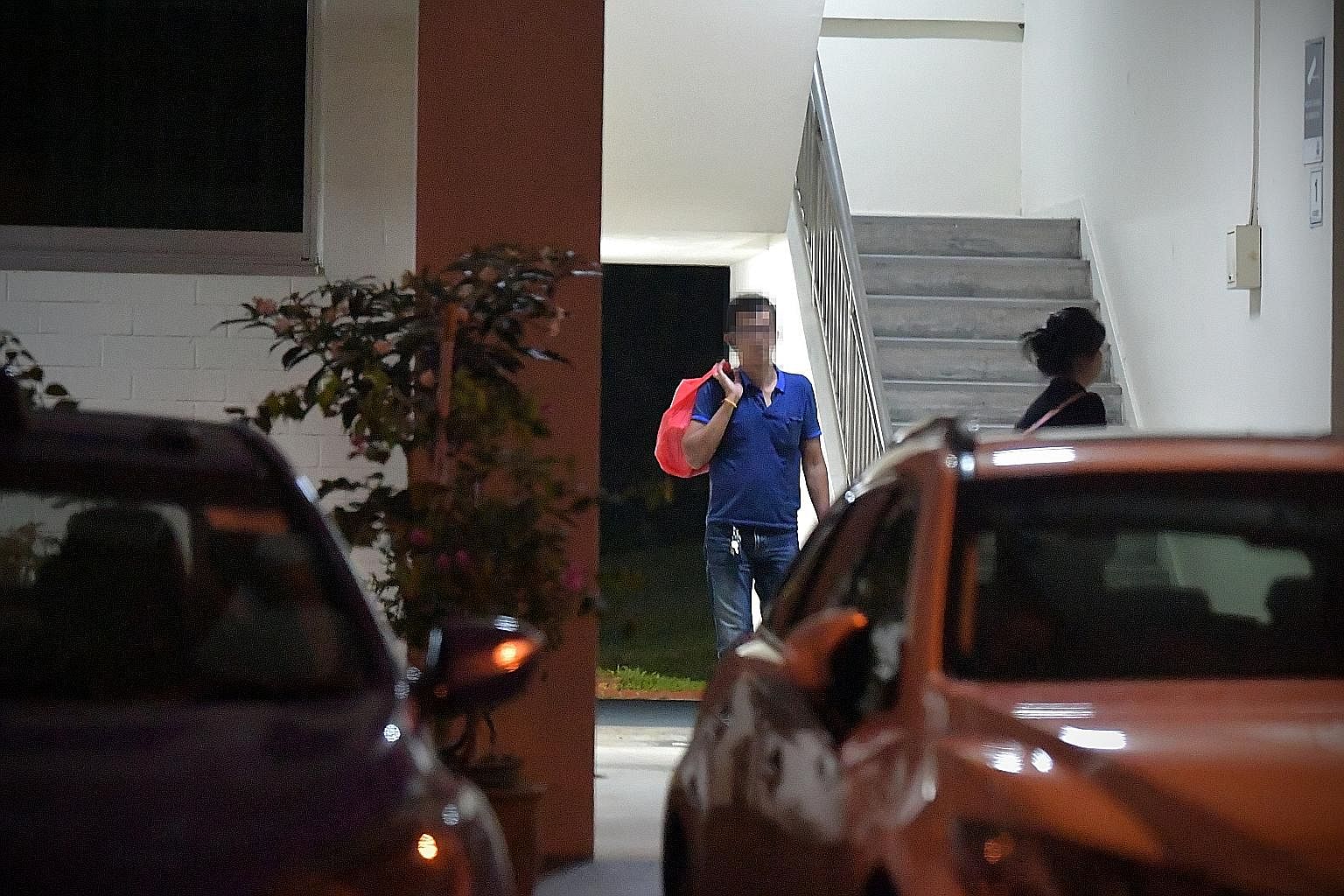 A photo taken last October of a man carrying a bag of duty-unpaid cigarettes he had just bought. Contraband cigarette touts have become harder to spot now due to a cigarette supply shortage.