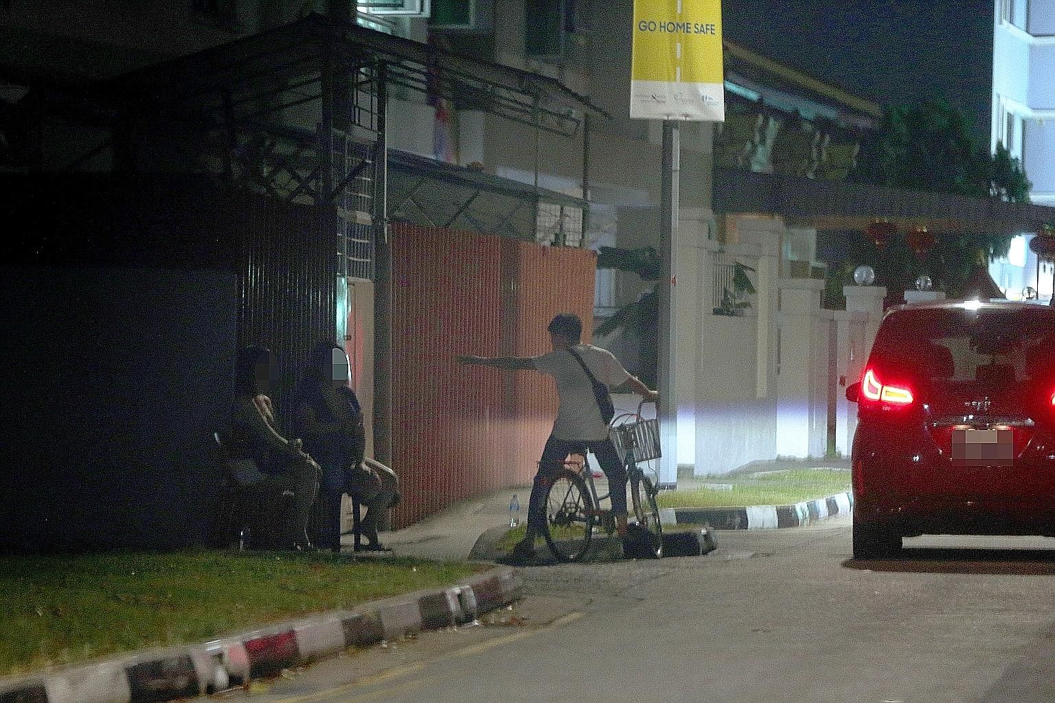 Two sex workers sitting near a licensed brothel in Lorong 16 Geylang at about 10pm last Thursday. This part of Geylang, known for licensed prostitution, was a virtual ghost town as the women waited for more than two hours without getting any clients.