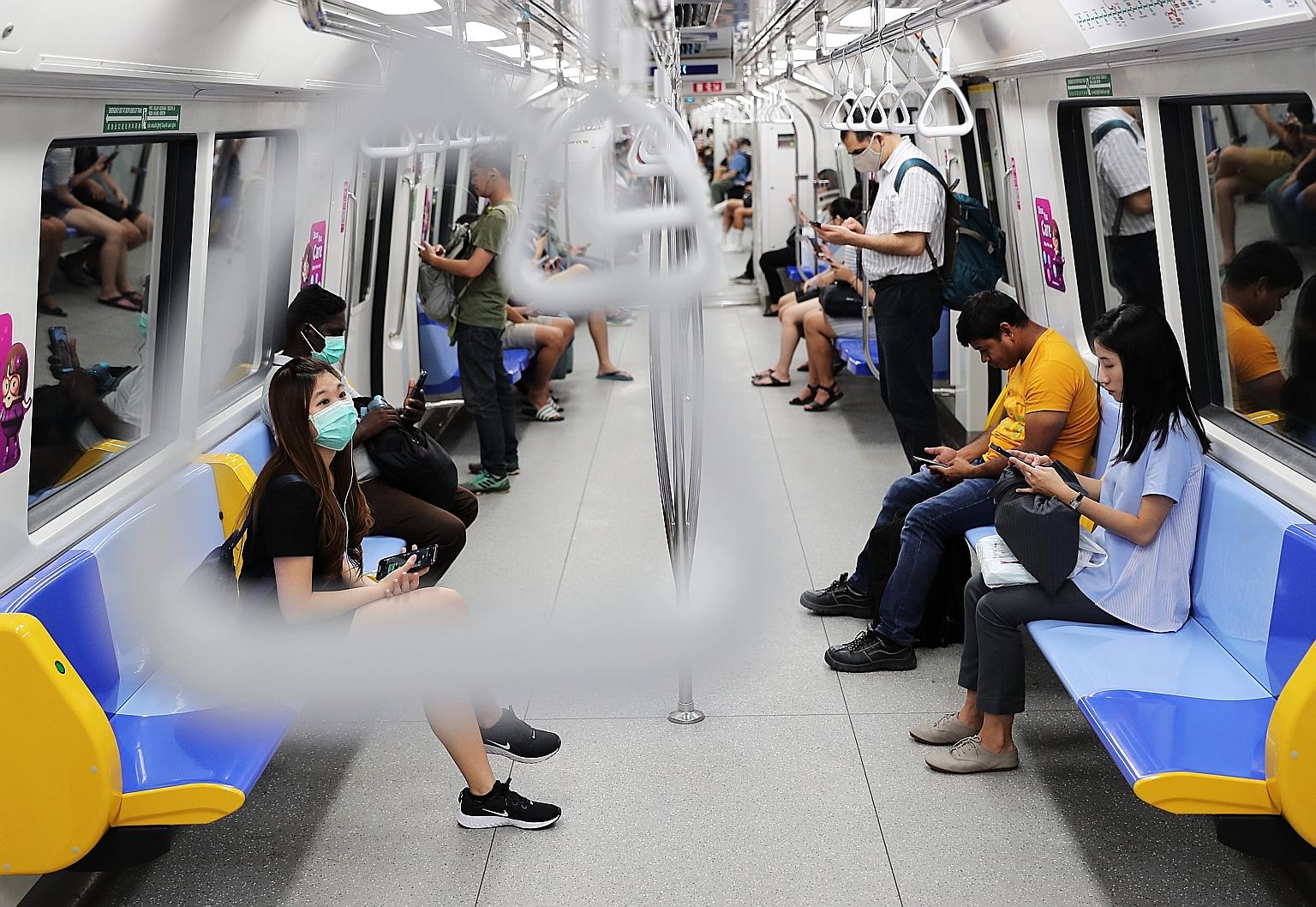 Commuters on the MRT last Wednesday. Ridership is expected to fall further when stricter stay-home measures kick in today.