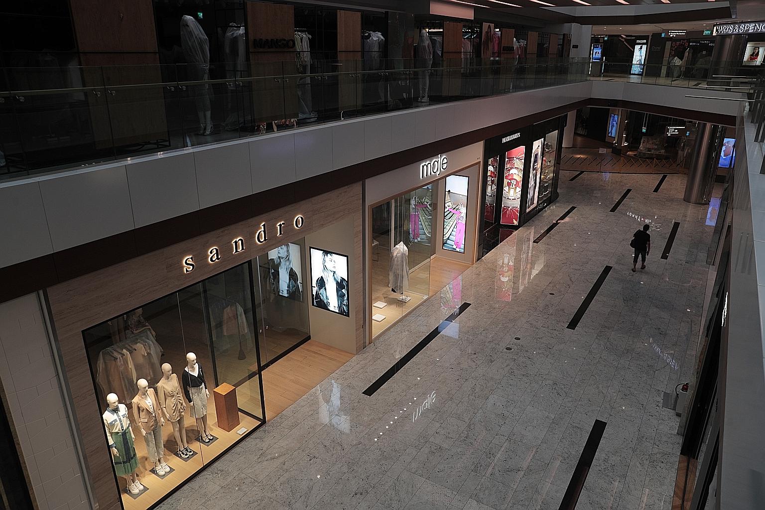 An almost deserted Raffles City mall at around 5.30pm yesterday. Most workplaces - aside from those offering essential services and in key sectors - are closed until May 4 to break the chain of Covid-19 transmission.