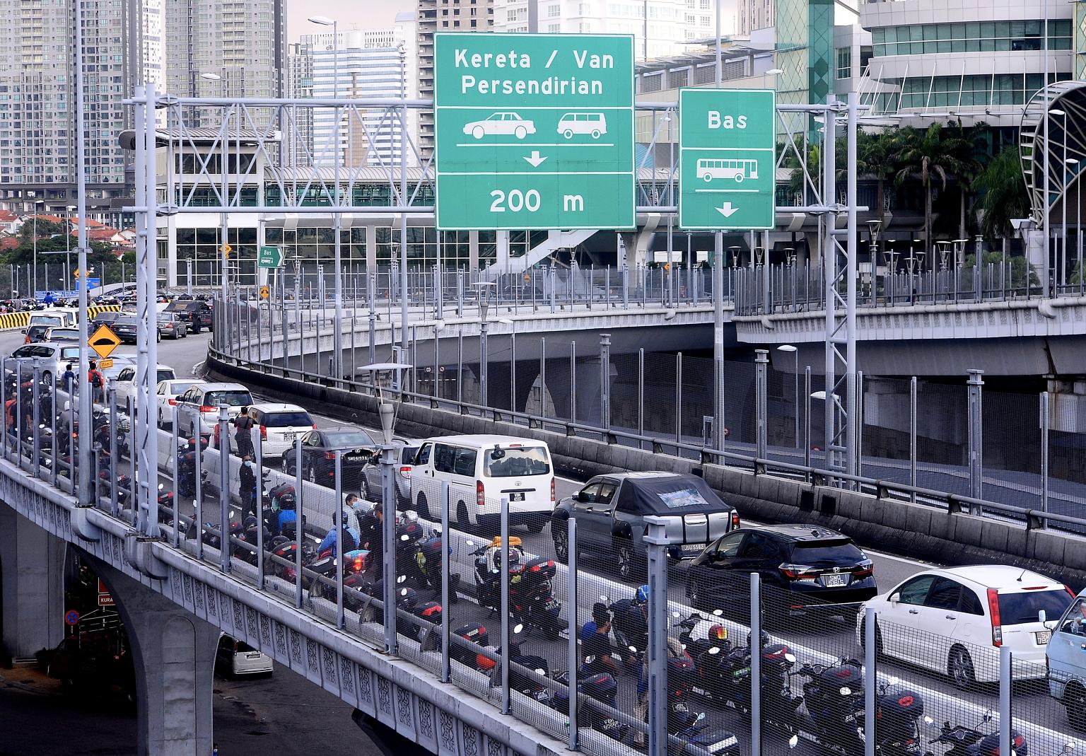 Traffic at the Johor Baru checkpoint. Some Malaysians returning from Singapore were caught off-guard when they were sent to a government quarantine centre in JB. PHOTO: BERNAMA