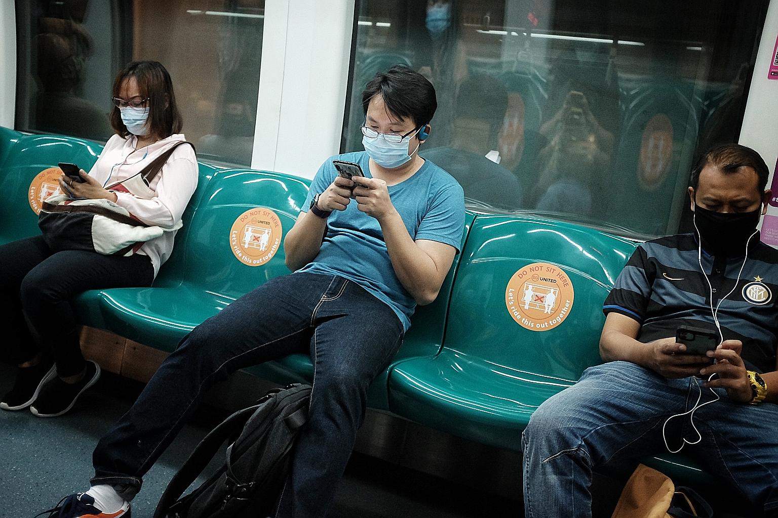 MRT commuters observing safe distancing at about 9.30am yesterday. Standing spaces and seats that should be avoided will be marked out with stickers, and thermal scanners will be deployed at selected MRT stations.