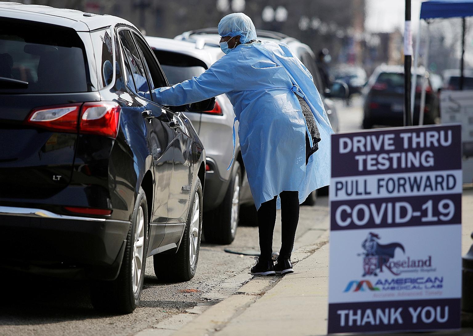 Motorists waiting in line to get tested for Covid-19 in Chicago on Tuesday. A very high portion of infected people are now believed to be asymptomatic, strengthening the argument for everyone to cover their faces while outdoors.