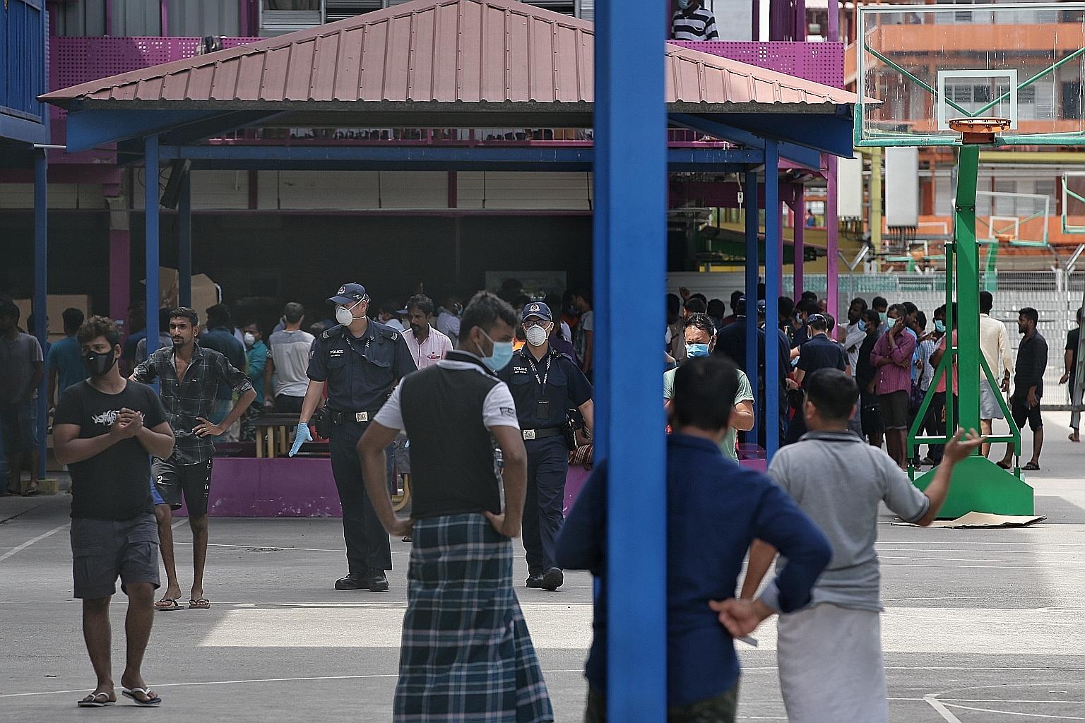 Police officers at the S11 Dormitory @ Punggol on Monday. Each forward assurance support team, or "Fast" team, comprises officers from the Singapore Armed Forces, police and Ministry of Manpower. ST PHOTO: KEVIN LIM