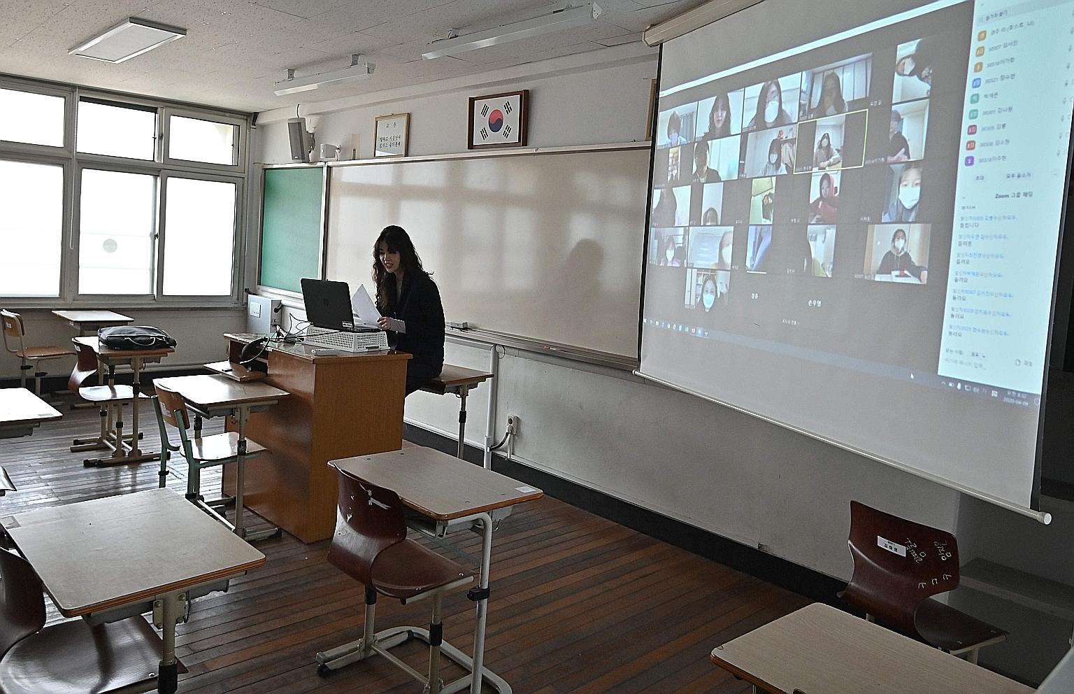 A teacher in Seoul conducting an online class for her students who are staying home amid measures to contain the coronavirus outbreak in South Korea. The country started the new school term yesterday with virtual classes for middle and high school se