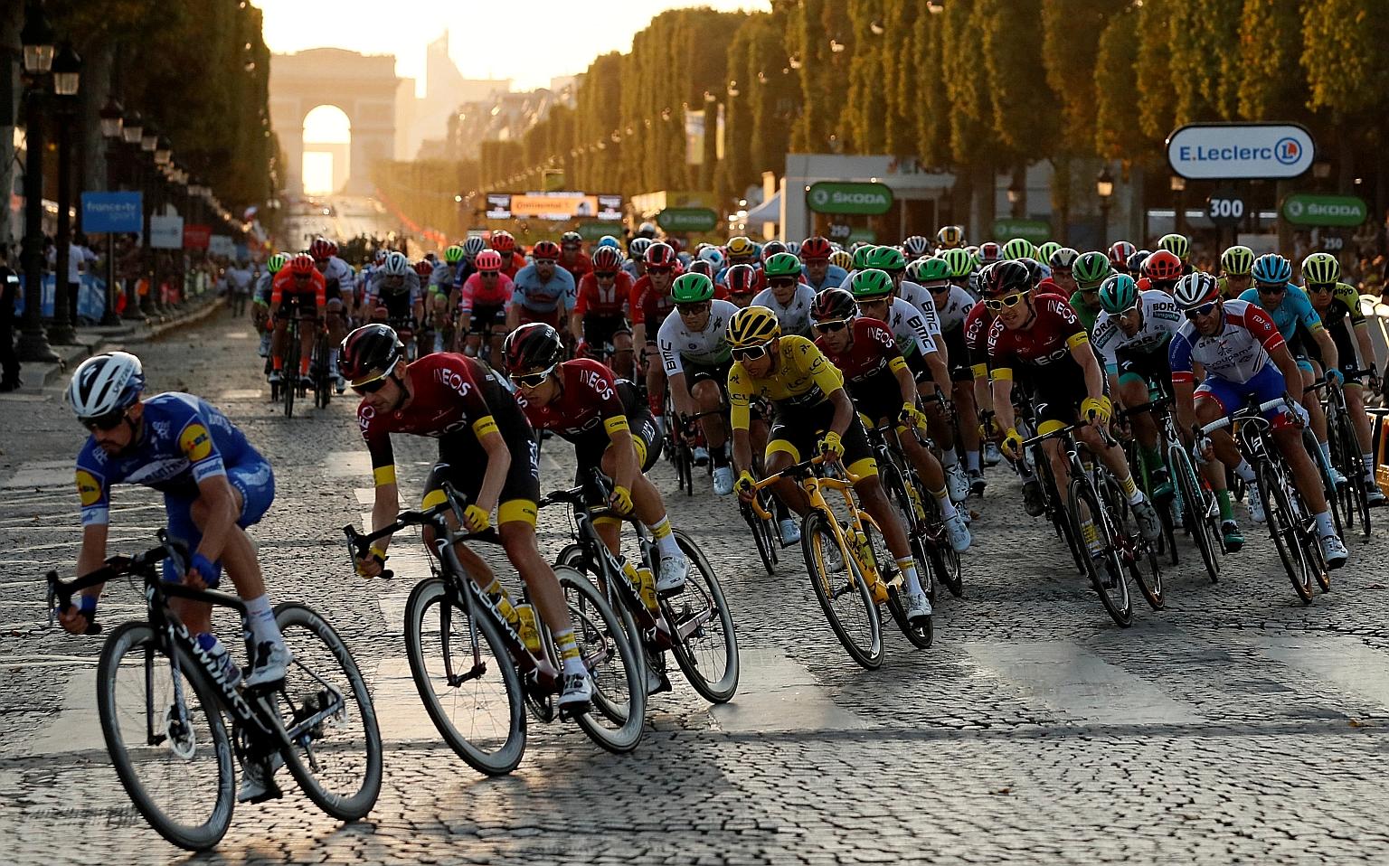Team Ineos rider Egan Bernal, of Colombia, in the overall leader's yellow jersey, in the peloton on the Champs-Elysees in the final stage of last year's Tour de France. He was the first Latin American winner of the race. 