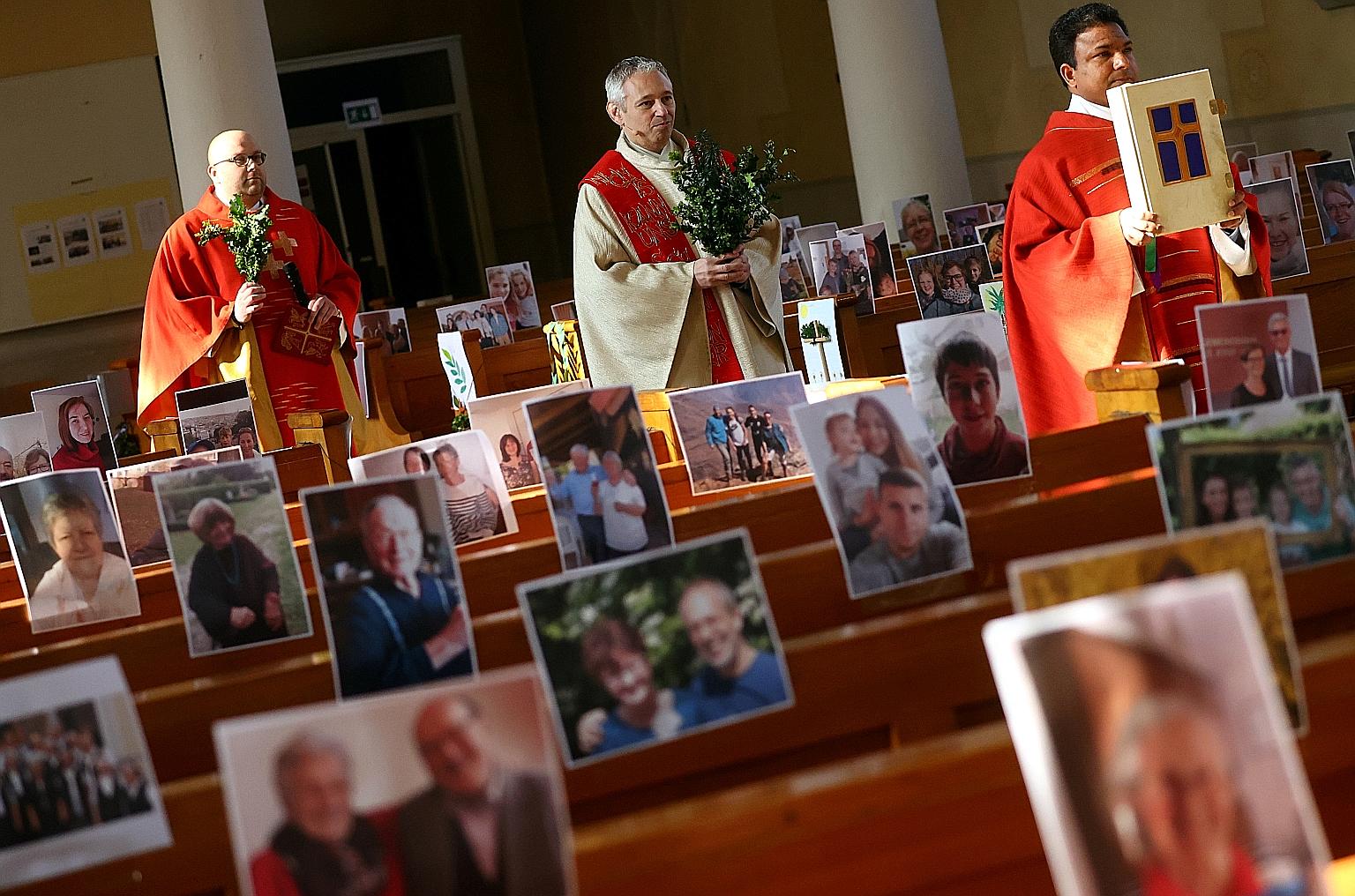 Father Joachim Giesler holding mass on Palm Sunday at his church in the German city of Achern. He had pasted pictures of his parishioners on empty pews. It was such a hit with the homebound parishioners that Father Giesler will do it again on Easter