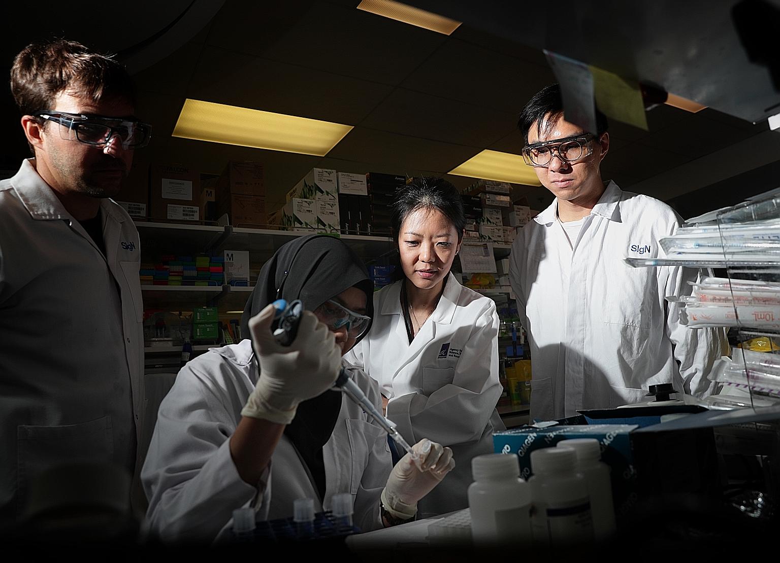 A*Star researchers at work in February. Laboratory work for projects has been put on hold during the circuit breaker period. However, researchers from institutions like A*Star and universities such as the National University of Singapore and Nanyang