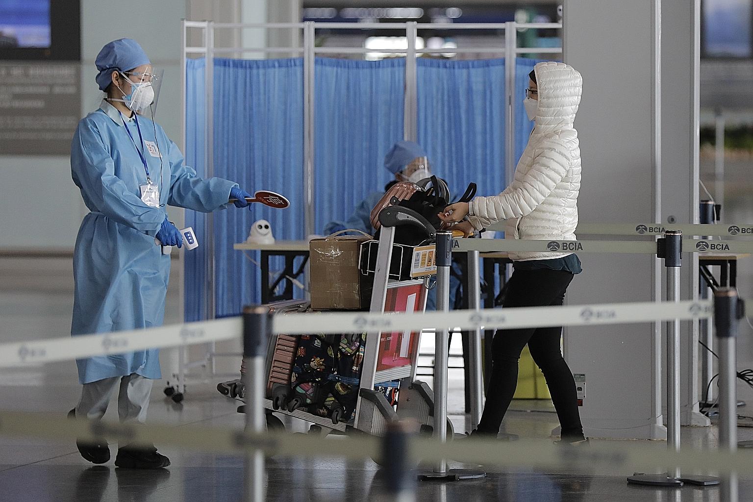 A passenger at Terminal 3 of Beijing Capital International Airport. China fears a second wave of cases triggered by arrivals from overseas.