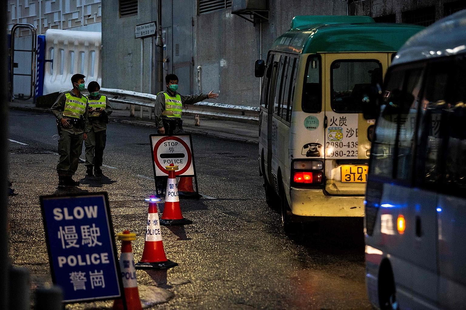 Police manning a road block before local residents arrived at Chun Yeung estate in Hong Kong to begin their 14 days of quarantine on March 4. Hong Kong officers face a unique challenge as they battle the pandemic amid simmering social discontent, wit