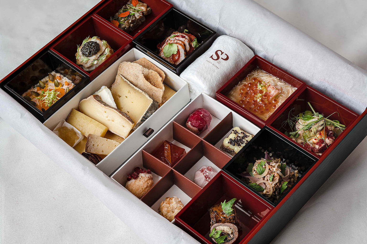 Saint Pierre’s omakase bento box comprises eight items plus cheeses and desserts for home delivery. 