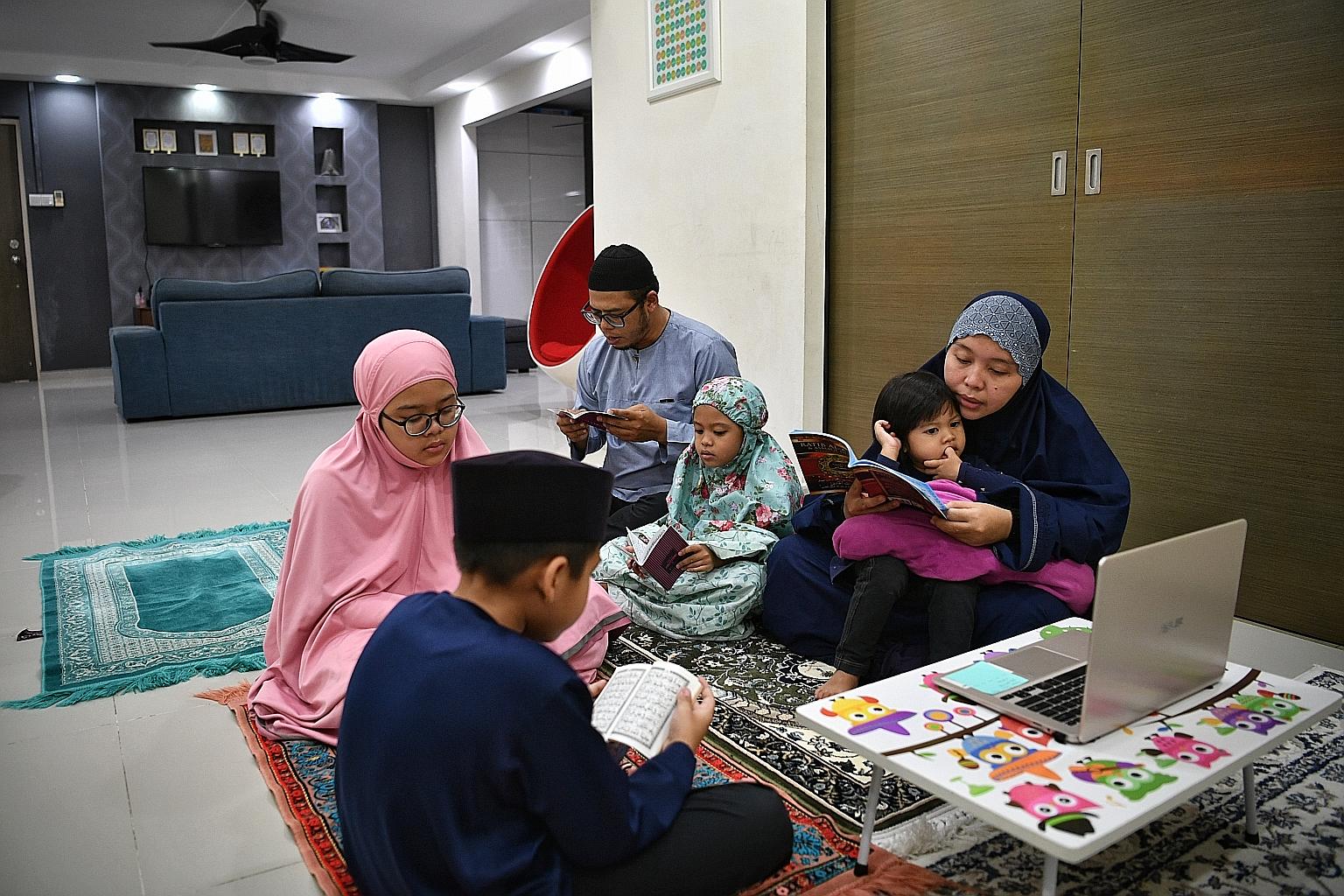 Police officers with protective masks outside the National Mosque in Kuala Lumpur last month. Malaysia said last Friday that it would extend its movement control order to April 28. PHOTO: REUTERS Devotees adhering to social distancing measures during