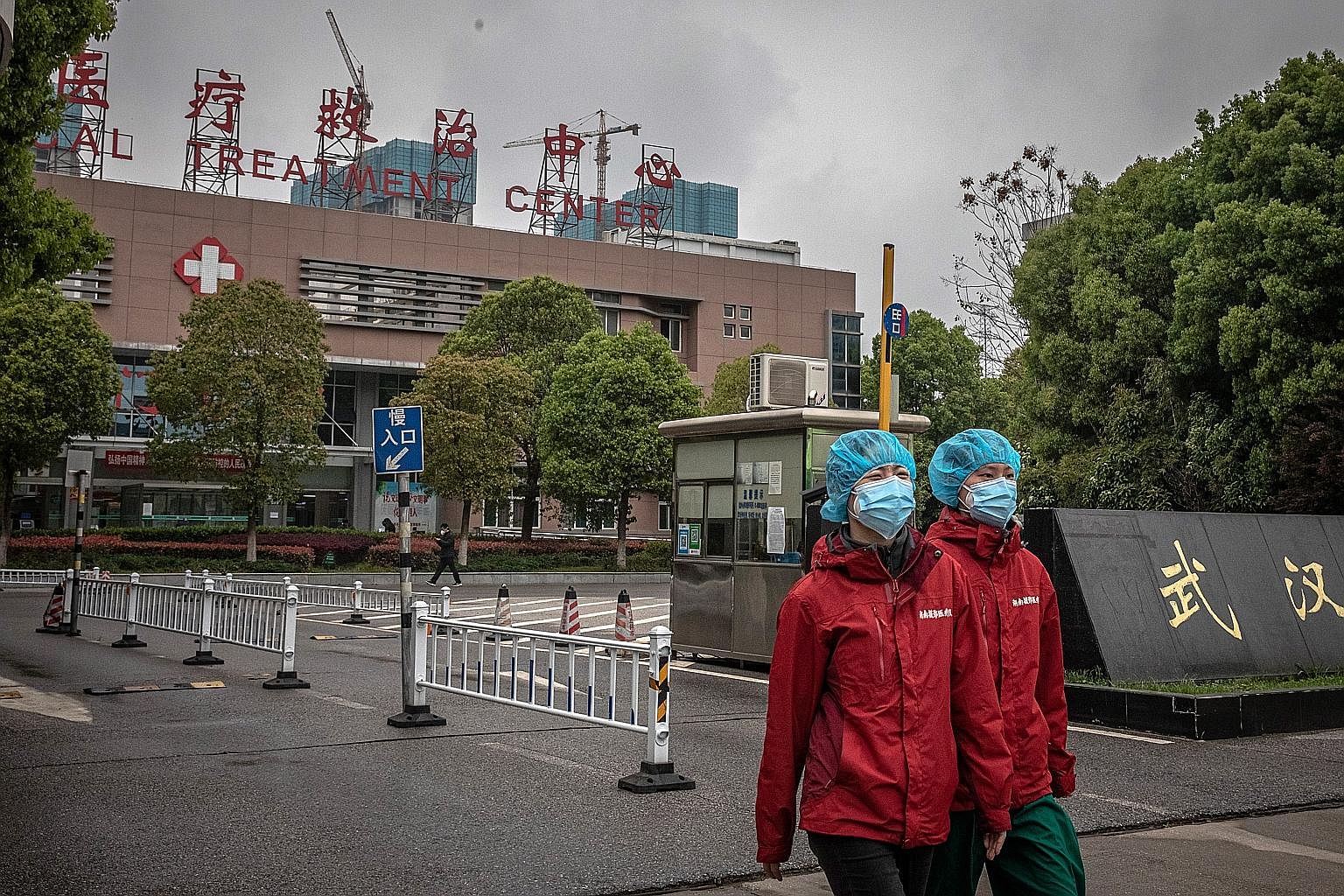 From top: Cyclists and walkers in Wuhan's East Lake Plum Flower Garden on Sunday, after the city's lockdown ended; medical workers outside Jinyintan Hospital last Tuesday; employees in protective gear disinfecting a visitor to the city's Zonsen Medic