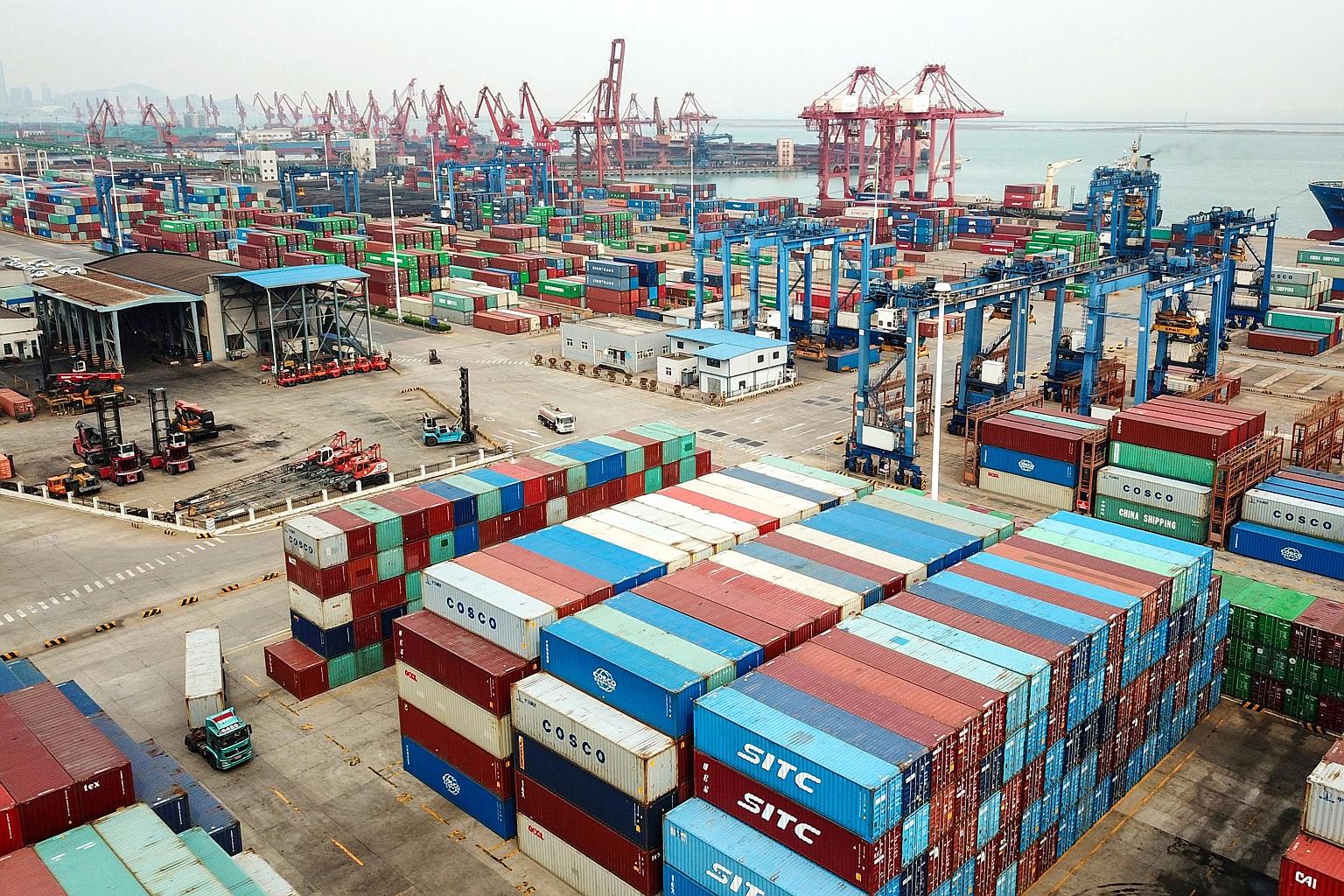 An aerial photo showing containers stacked at a port in Lianyungang, China's eastern Jiangsu province, yesterday. China's foreign trade fell again in March even as businesses returned to work after the worst of the country's coronavirus outbreak, wit