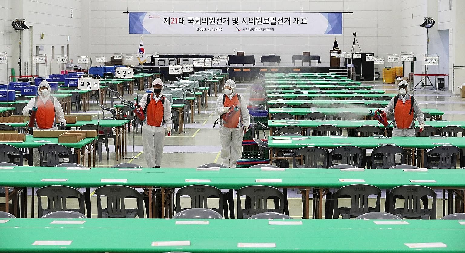 Health workers disinfecting a ballot station in Sejong, South Korea, yesterday, ahead of today's general election. The number of new coronavirus cases in the country has fallen from a high of 813 on Feb 29 to below 50 for six days in a row, as an int