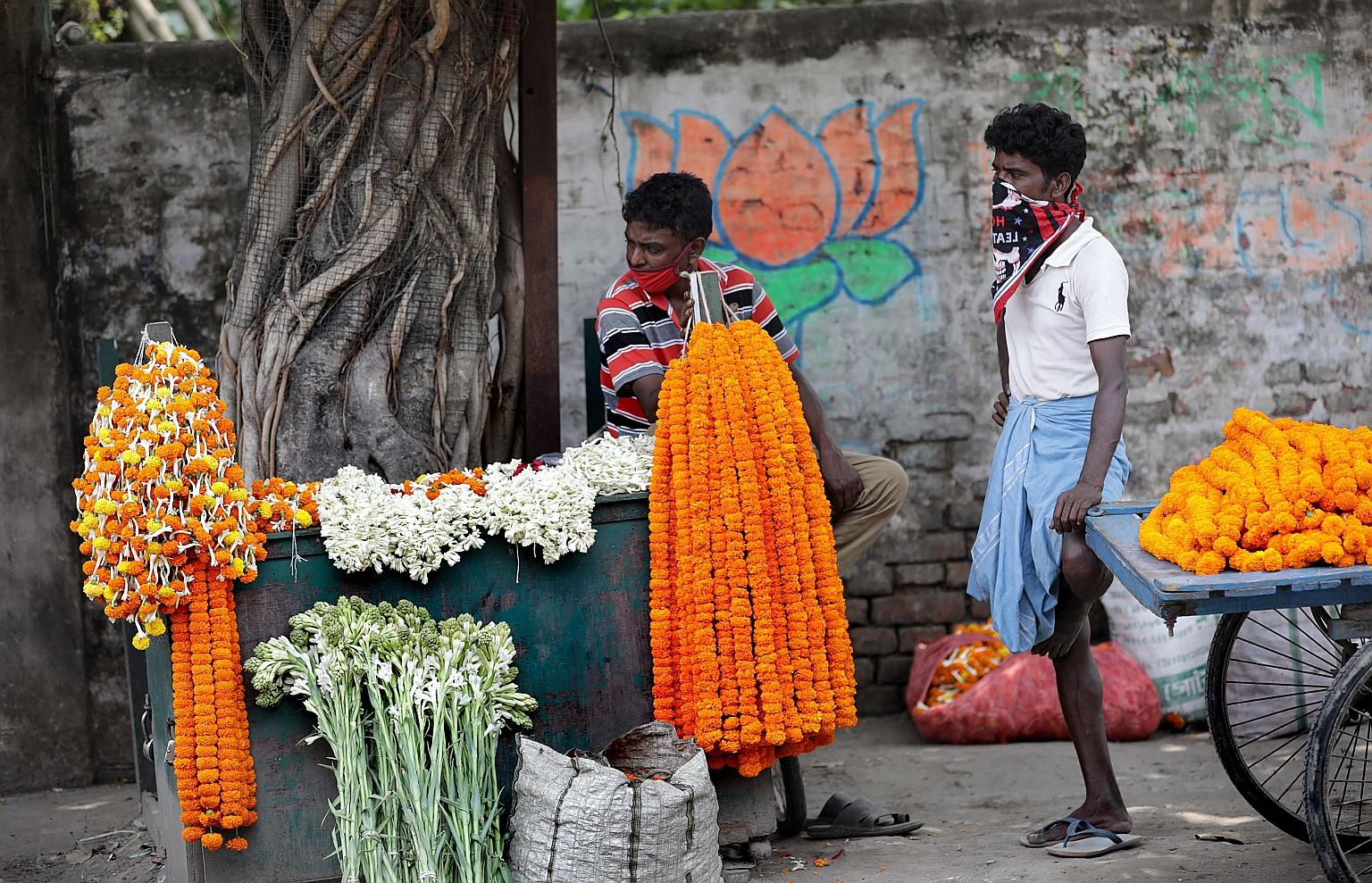 Flower vendors waiting for customers during a lockdown to combat the coronavirus pandemic in Kolkata yesterday. The lockdown has been extended till May 3.