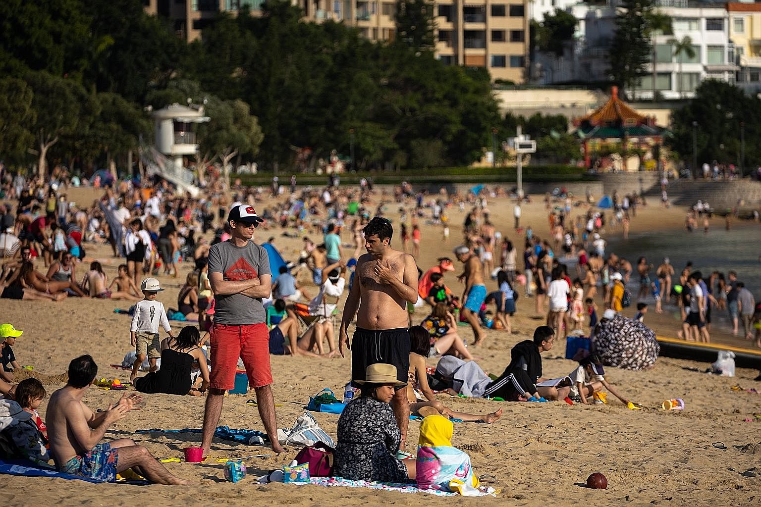 People crowding Repulse Bay beach in Hong Kong on Sunday. Countries and territories such as South Korea, Hong Kong and Taiwan prioritised different strategies, relying on rigorous contact tracing, widespread testing and early quarantining of all high