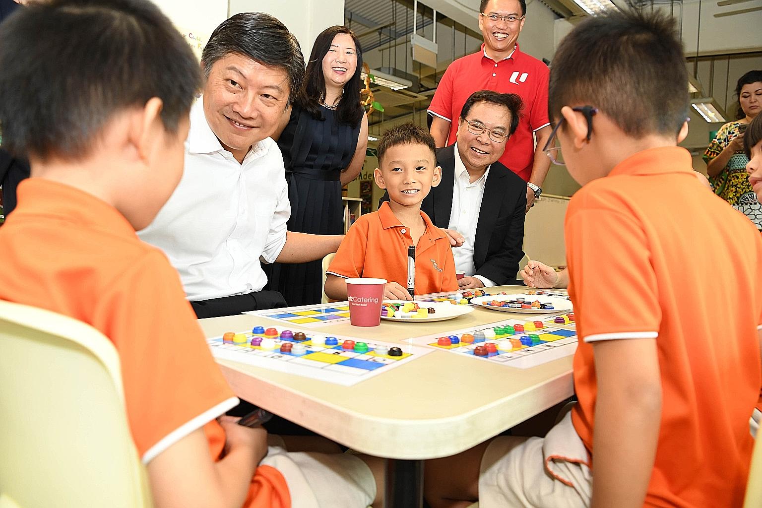 OCBC CEO Samuel Tsien (right) and NTUC secretary-general Ng Chee Meng with children of My First Skool at the launch of the OCBC-NTUC First Campus Bridging Programme last September. Looking on were NTUC First Campus chief child support officer Phoon C