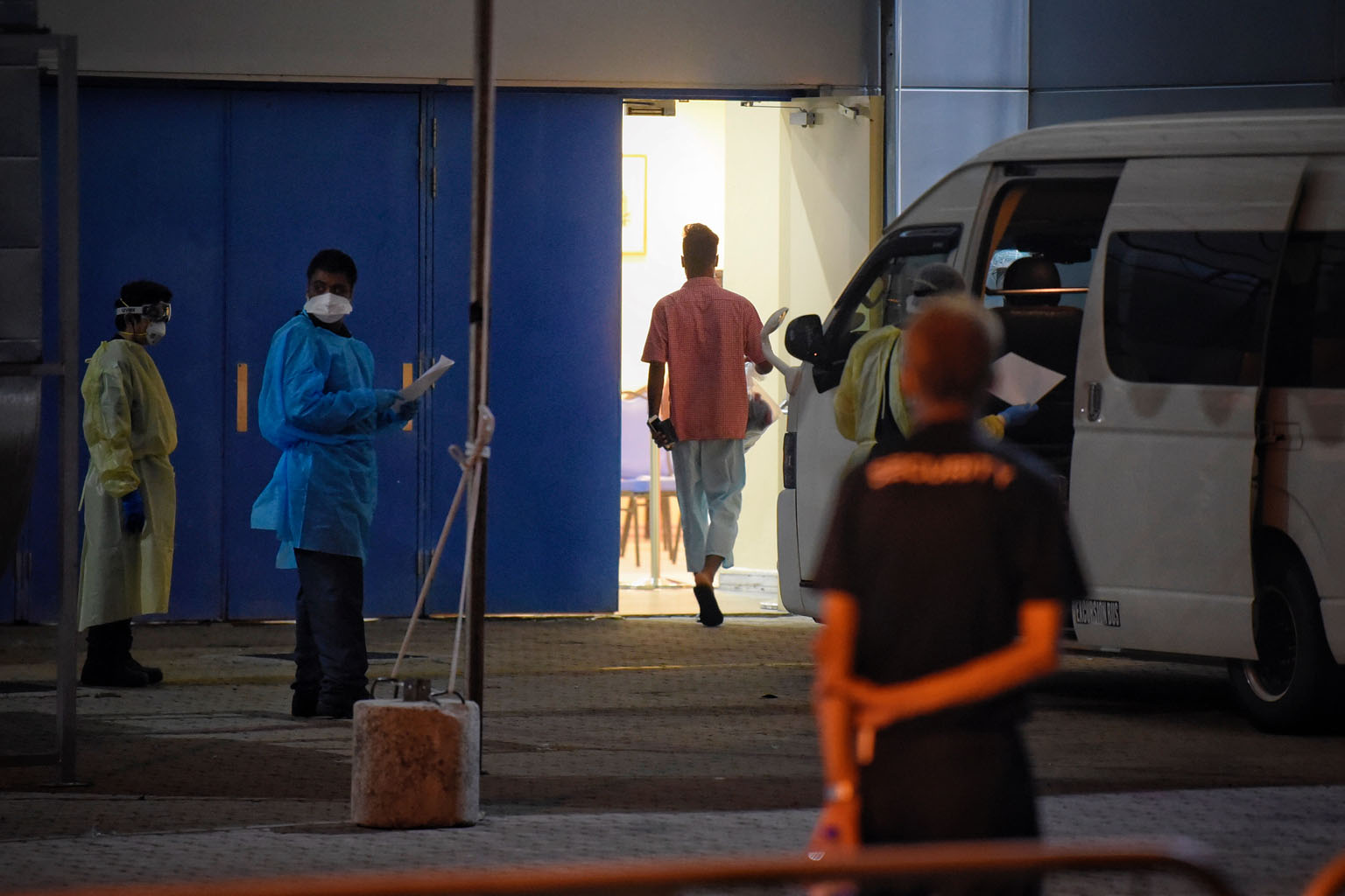 Staff at the Singapore Expo yesterday. Patients have been housed in two halls there, while four other halls will open progressively.