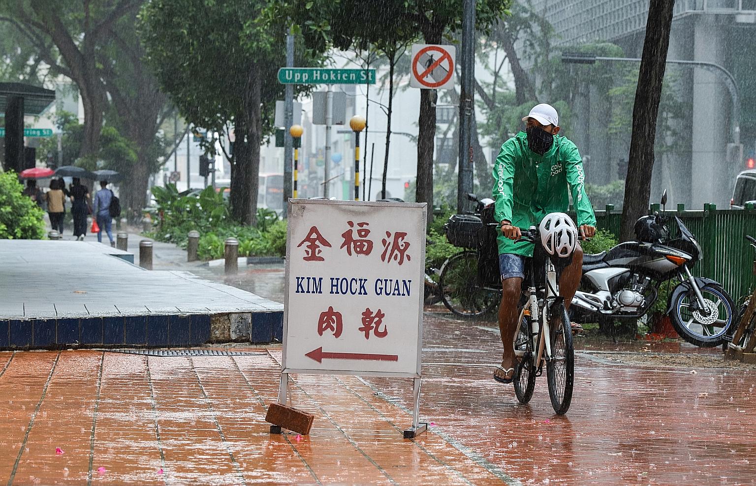Rain falling in the Chinatown area at about 1.30pm on Monday. Short thundery showers with frequent lightning are expected on most days in the next two weeks.