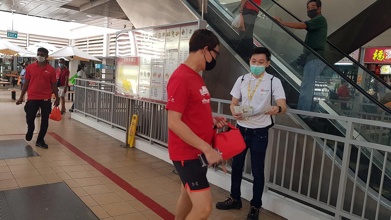 Mr Darren Ang, seen here giving out pamphlets to members of the public, said of his efforts as an SG Clean ambassador: "I don't see it as work - I see it as a very important mission." PHOTO: NATIONAL ENVIRONMENT AGENCY