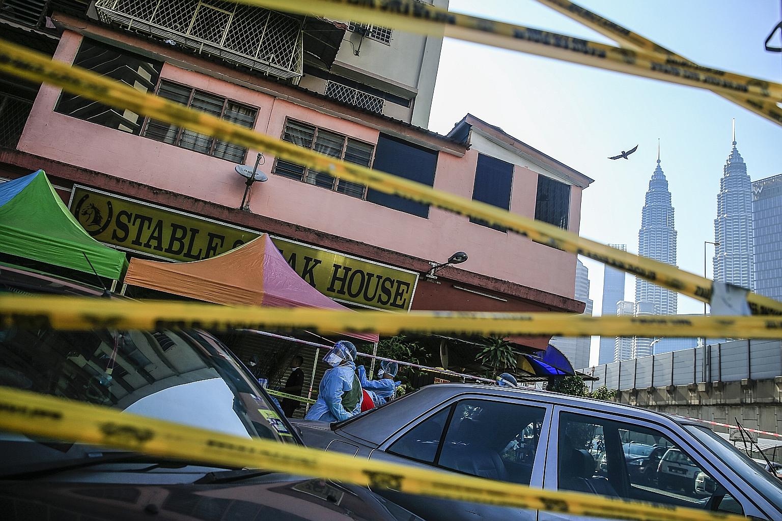 Malaysian health inspectors carrying out checks at a property in Kuala Lumpur this week. The country is under a movement control order.